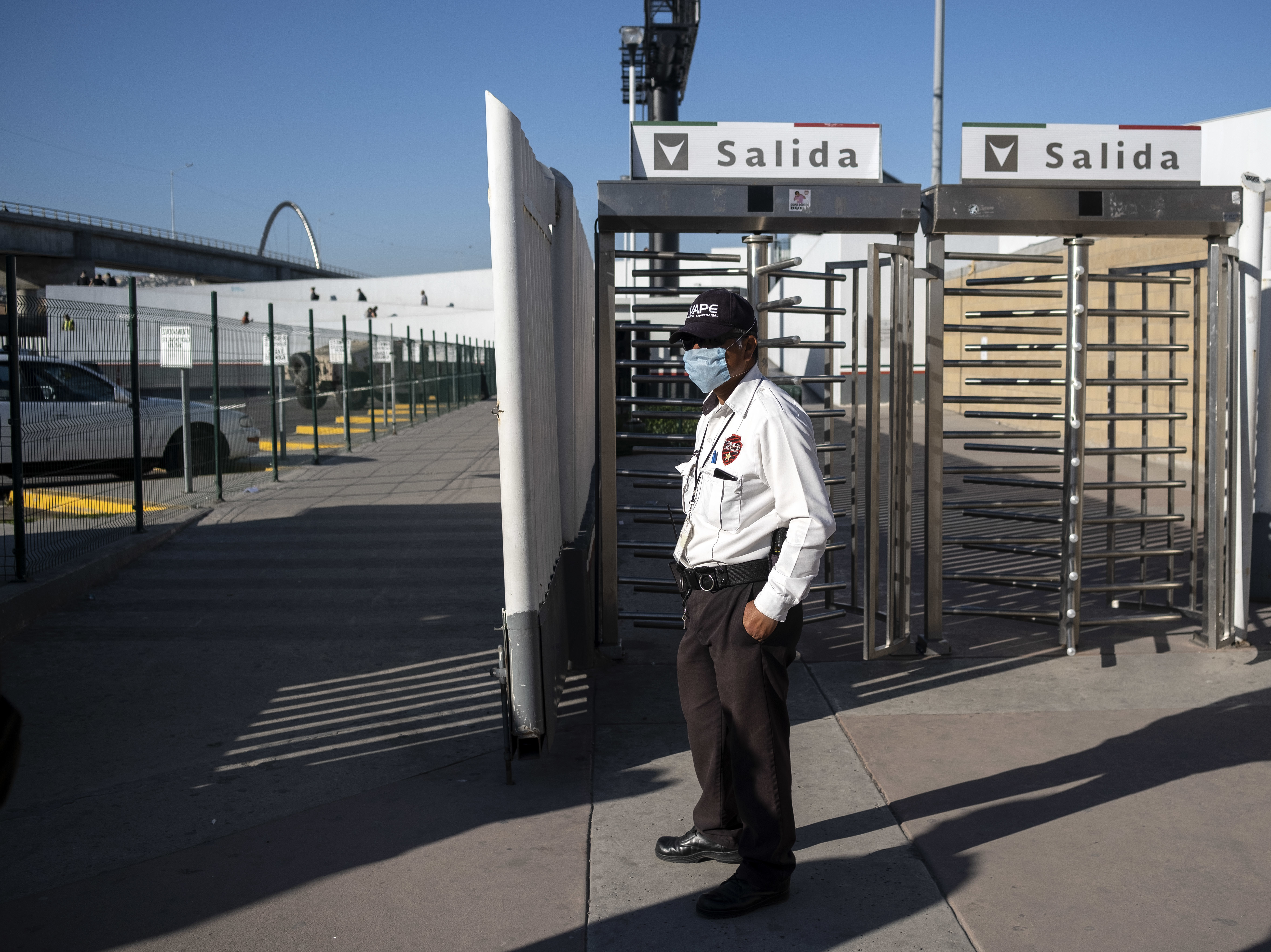 caption: A security guard stands at the El Chapparal Port of Entry on the U.S.-Mexico Border in Tijuana, Baja California state, Mexico, late last month. The two countries are said to be working out a deal to close their border to non-essential crossings.