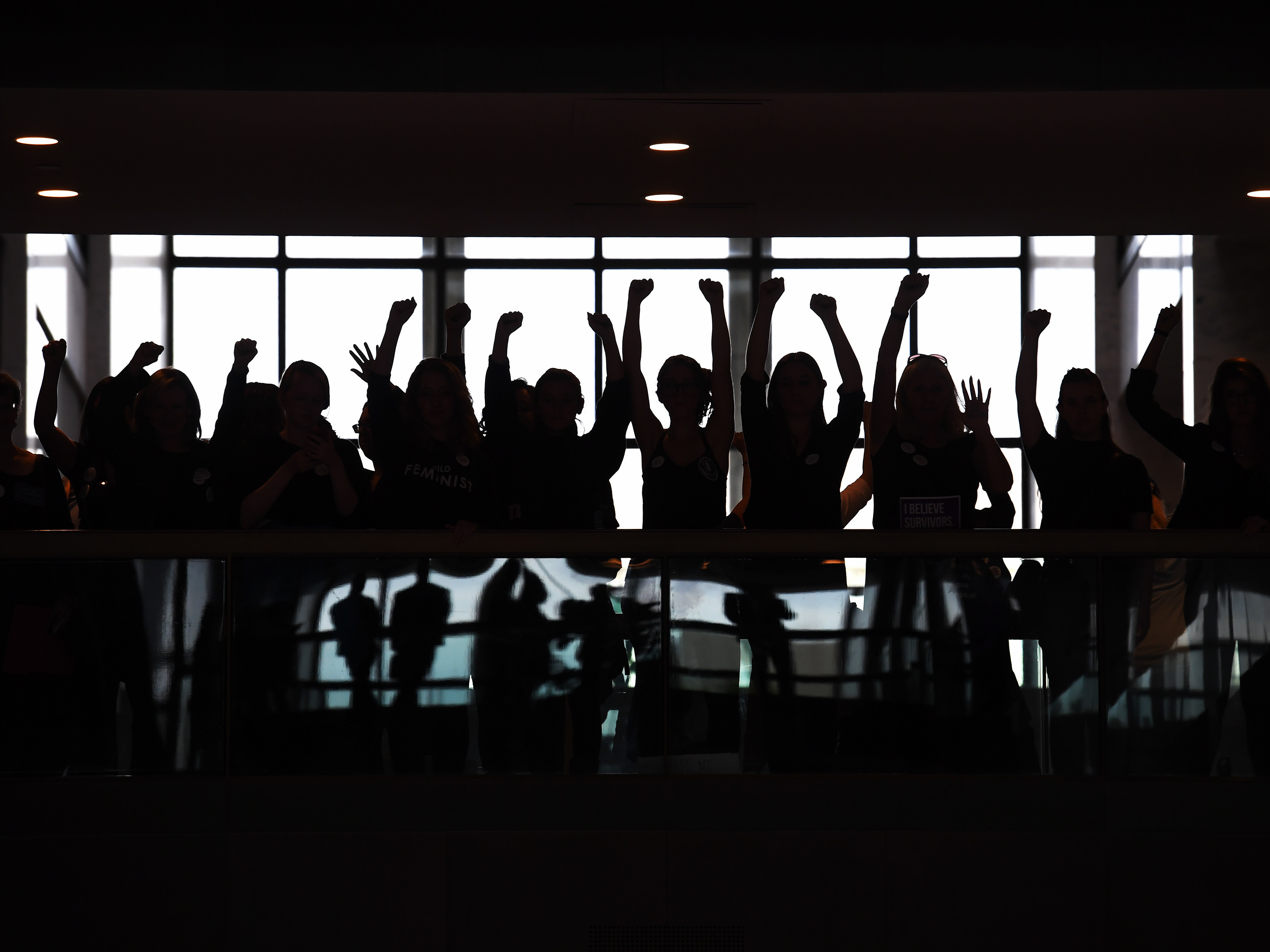 caption: People gather to protest Brett Kavanaugh on the day that he and Christine Blasey Ford testified on Capitol Hill in September.