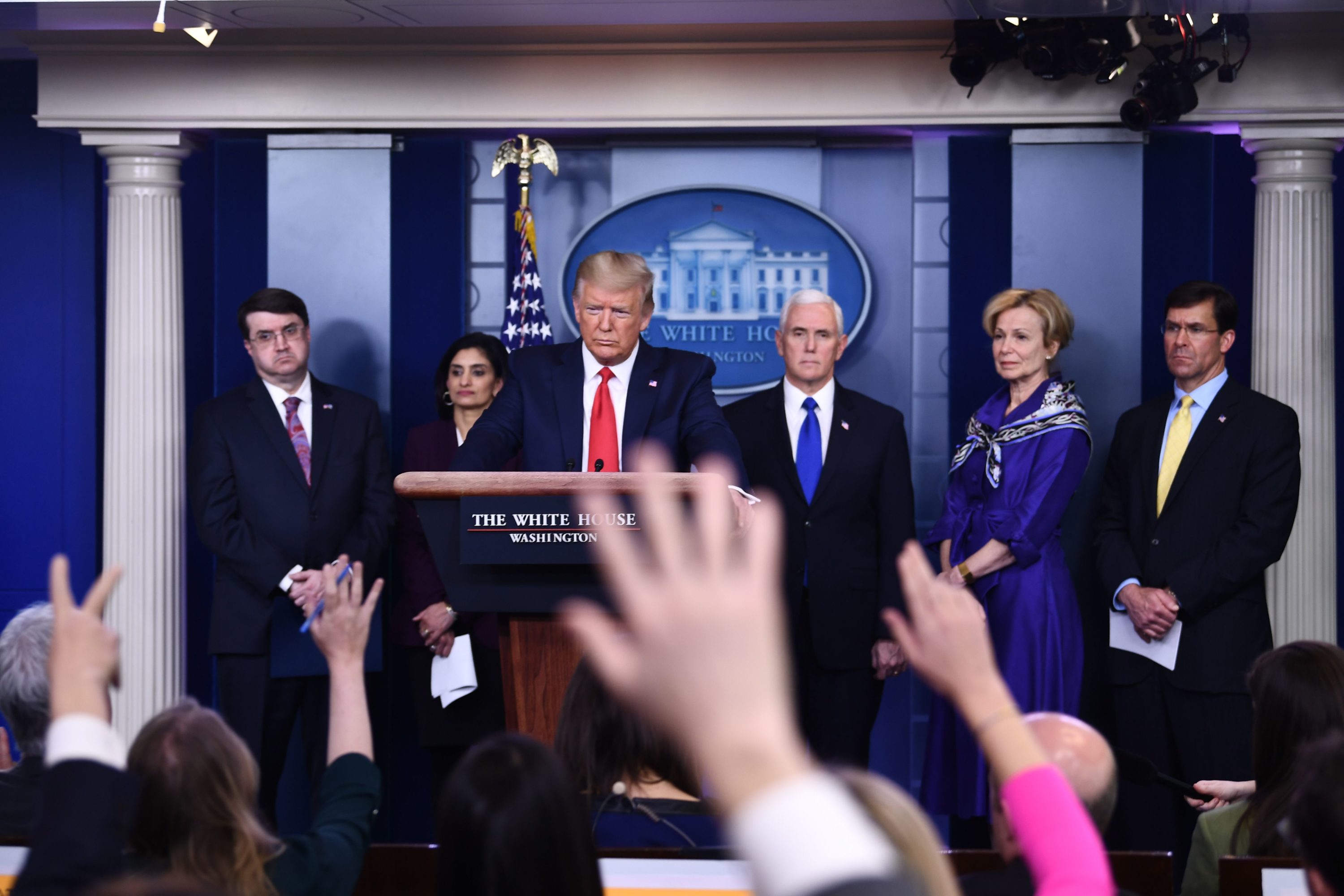 caption: U.S. President Donald Trump takes a question during the daily briefing on the novel coronavirus, COVID-19, at the White House on March 18, 2020, in Washington, DC. Trump ordered the suspension of evictions and mortgage foreclosures for six weeks as part of the government effort to ease the economic pain from the coronavirus pandemic. (BRENDAN SMIALOWSKI/AFP via Getty Images)