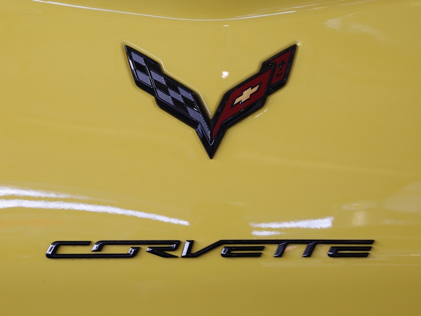 caption: The logo on the rear of a 2016 Corvette is on display at the Pittsburgh International Auto Show in 2016. General Motors says it will be offering an electrified Corvette as early as next year.