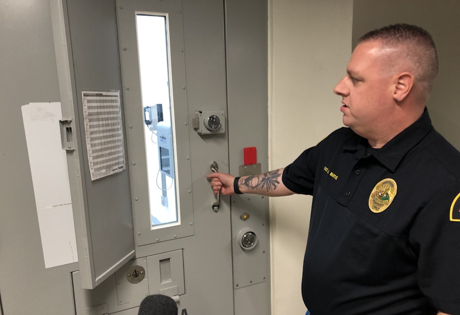 caption: Sgt. Michael Burtis in the Marysville Municipal Jail. He estimated that up to 90% of people housed there have some kind of substance use disorder.