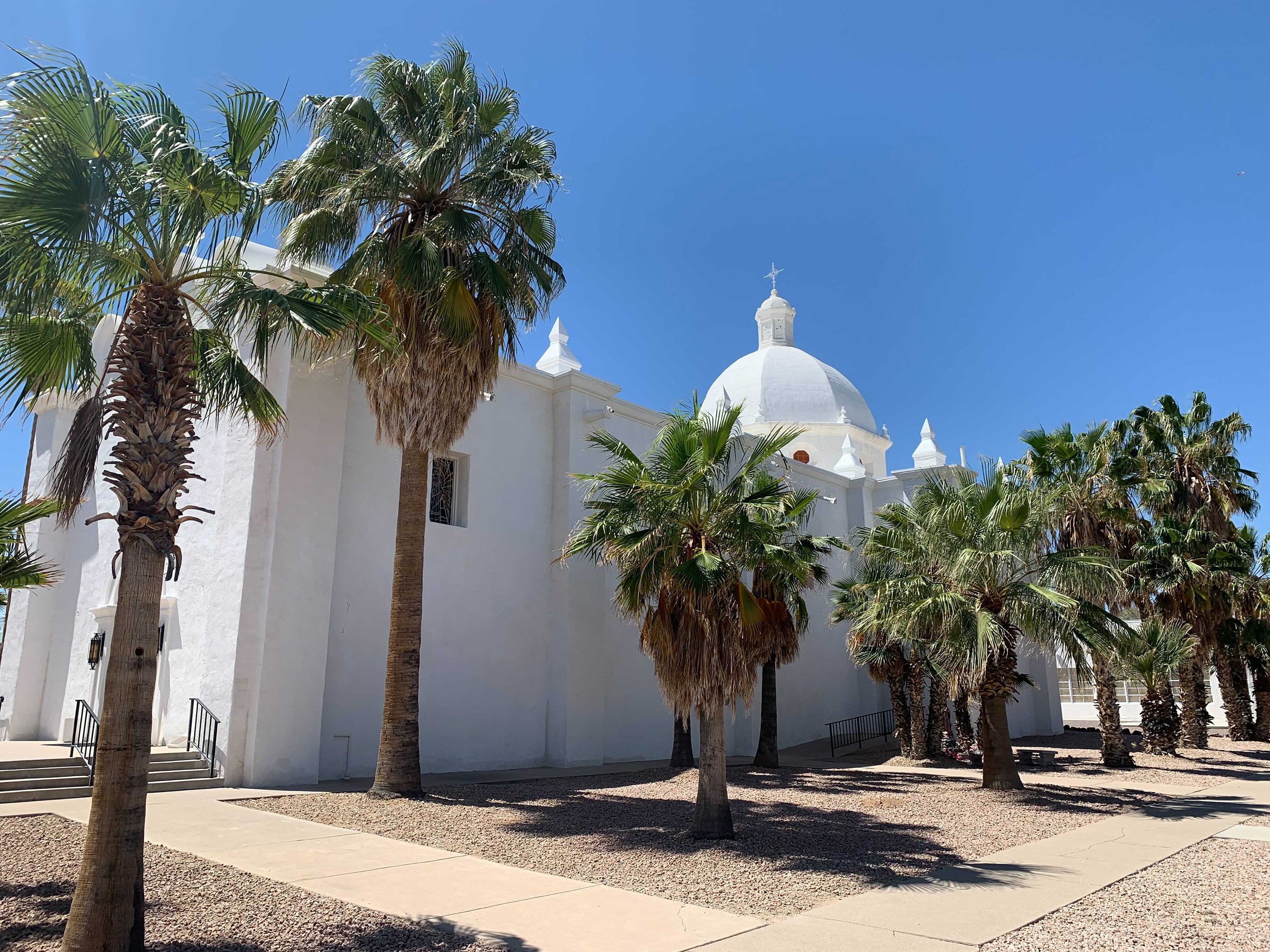 caption: Ajo, a former copper mining town more than 100 miles from Phoenix, is unincorporated. The U.S. government began dropping off migrants on the historic plaza in Ajo in March.