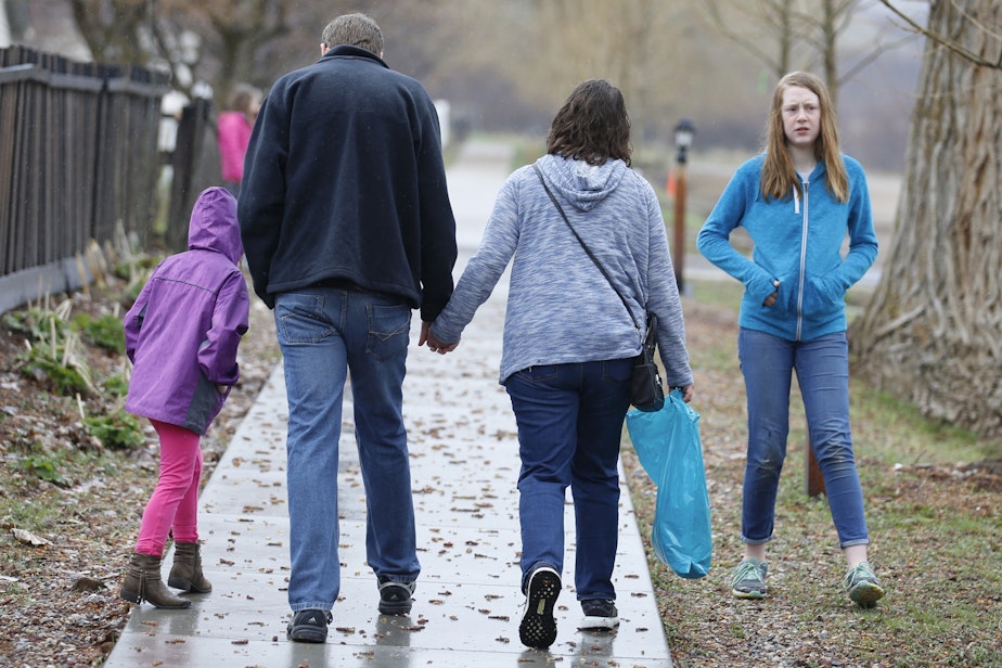 caption: Amy Coulter, center right, and her husband Mark walk together with their children April, 7, left, and Kendra, 12, at the Place Heritage Park in Salt Lake City, April 6, 2018. (Rick Bowmer/AP)