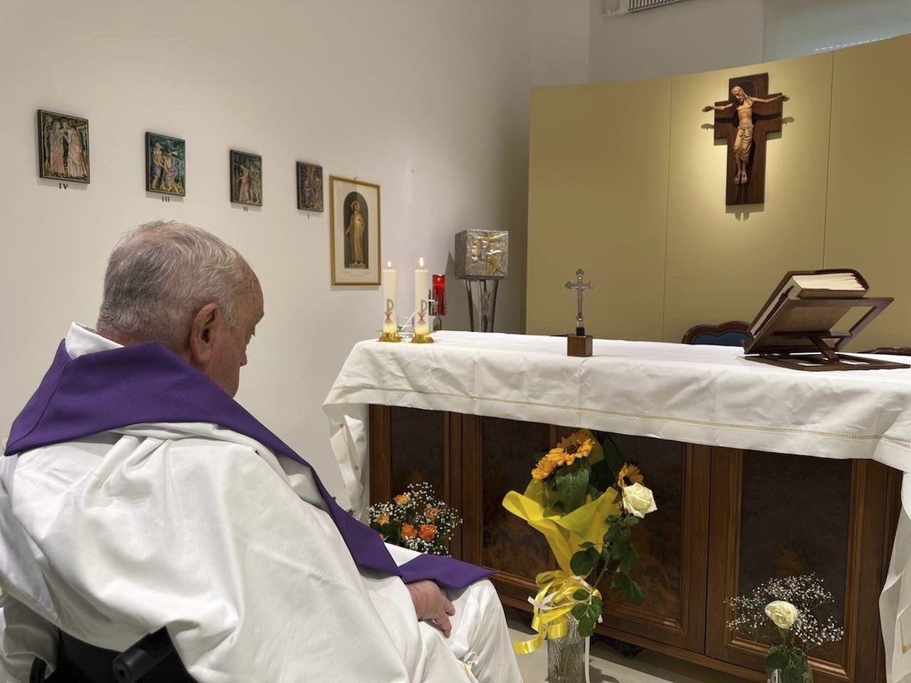 caption: In this photo released by the Vatican, Pope Francis is seen praying inside Rome's Gemelli Hospital on Sunday.