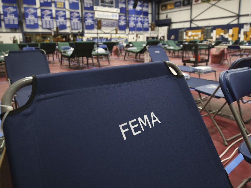 caption: A portable FEMA cot at a temporary medical facility in a gym at Southern New Hampshire University.