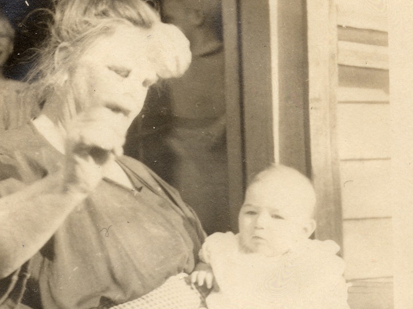 caption: The only surviving photo of Vivian Buck, here with her adoptive mother in 1924. This is the moment Vivian is determined by a eugenics researcher to be "feeble-minded" for not looking at a coin held in front of her face.