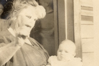caption: The only surviving photo of Vivian Buck, here with her adoptive mother in 1924. This is the moment Vivian is determined by a eugenics researcher to be "feeble-minded" for not looking at a coin held in front of her face.