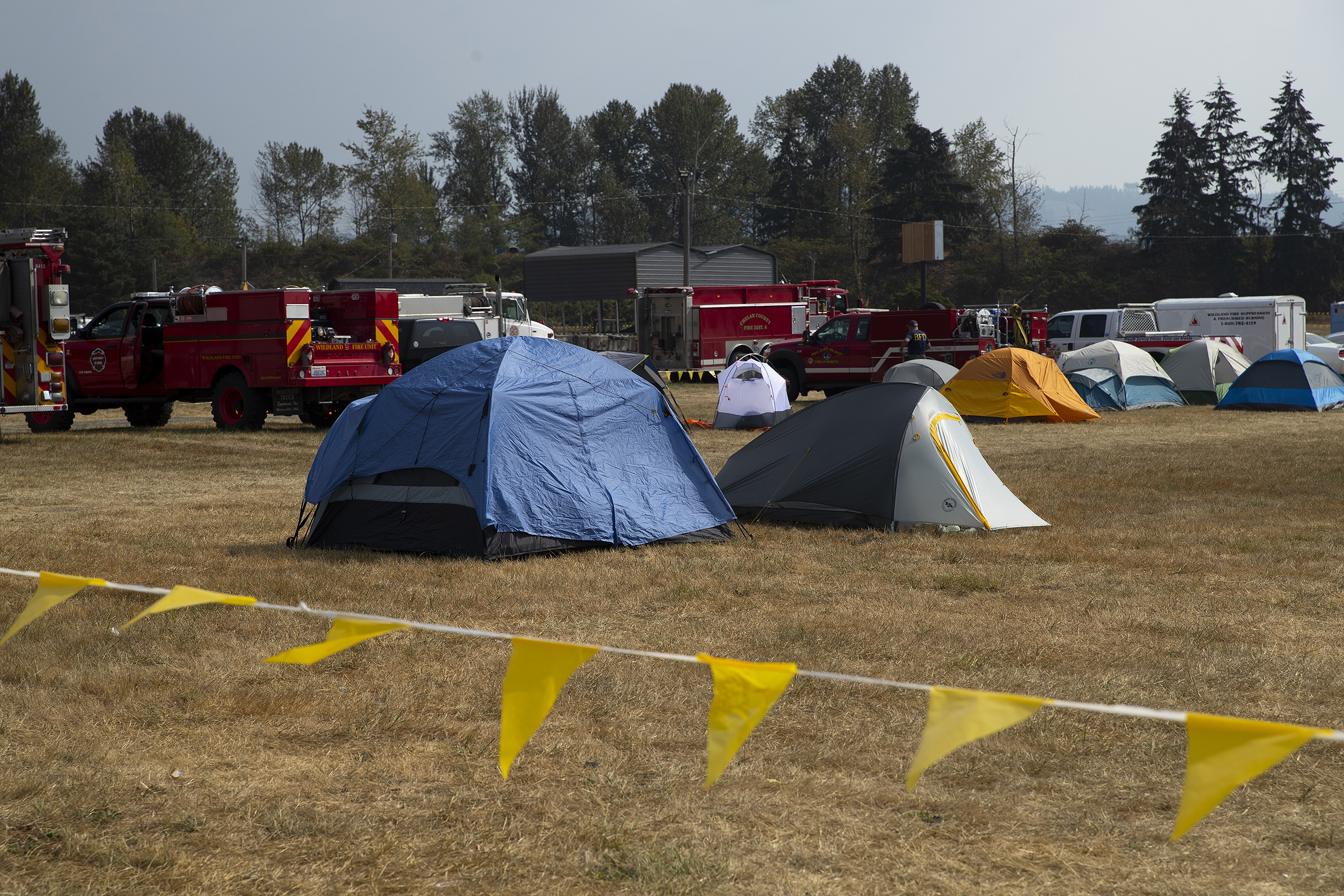 caption: Tents for firefighters are shown lined up at the Bolt Creek Fire incident command center on Monday, September 12, 2022, at the Evergreen State Fairgrounds in Monroe. 