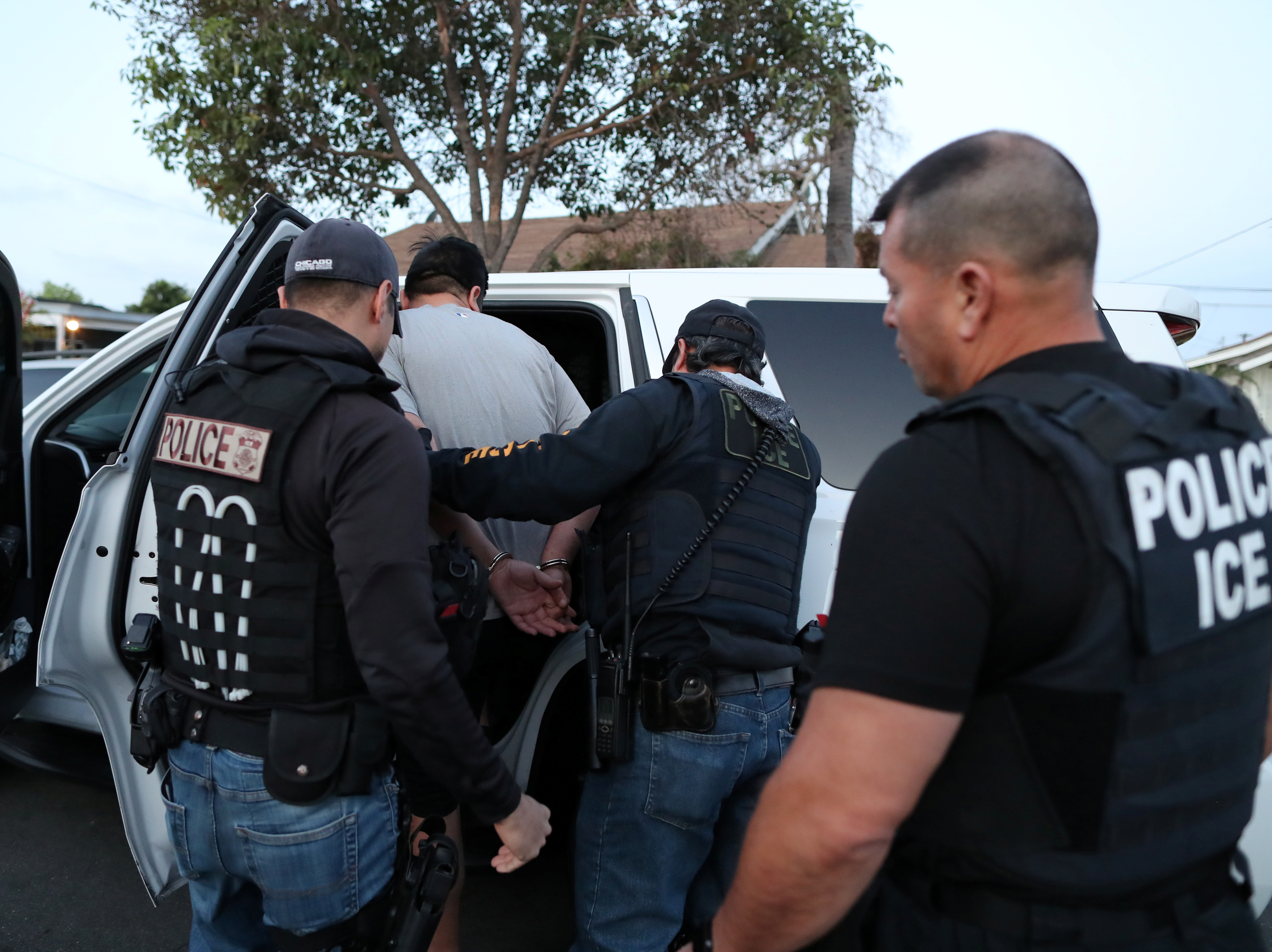 caption: ICE Field Office Director, Enforcement and Removal Operations, David Marin and U.S. Immigration and Customs Enforcement's (ICE) Fugitive Operations team make an arrest at a home in Paramount, Calif., on March 1, 2020.