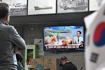 caption: Visitors watch a news broadcast showing file footage of a North Korean missile test at the ferry terminal of South Korea's eastern island of Ulleungdo, in the East Sea, also known as the Sea of Japan, on Thursday.