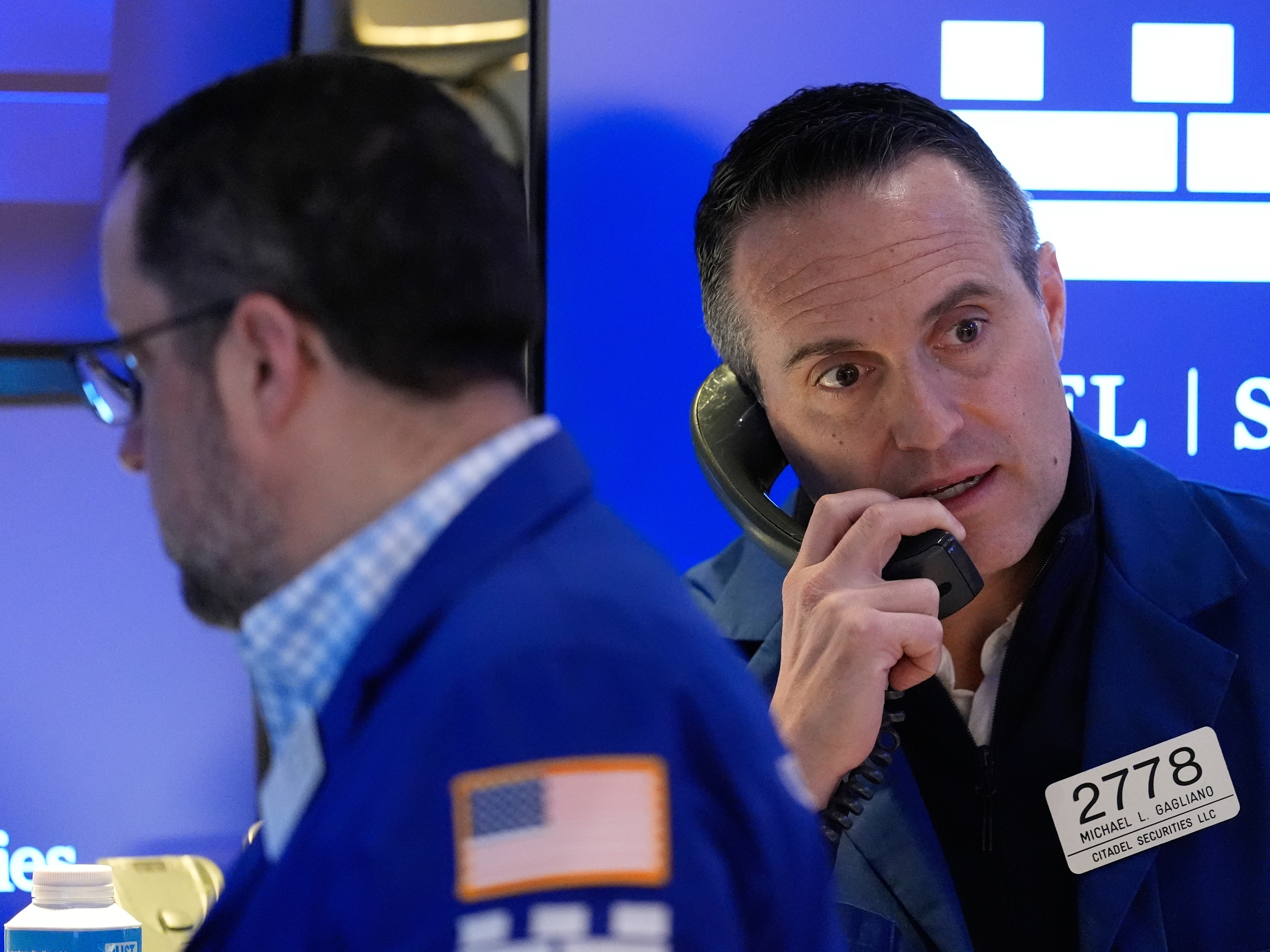 caption: Michael Gagliano works on the floor at the New York Stock Exchange on Friday.