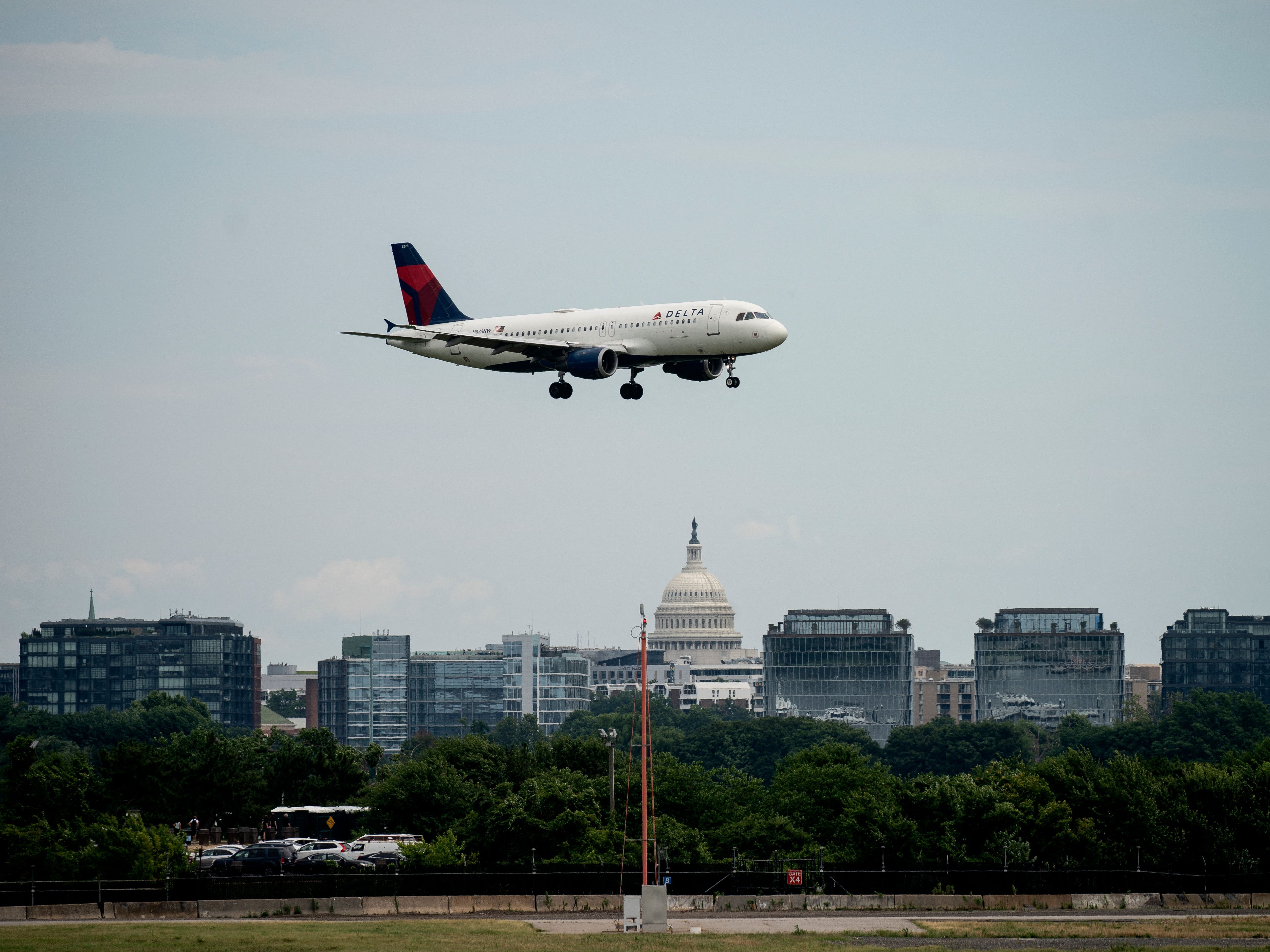 caption: A Delta Air Lines flight approaches Ronald Reagan Washington National Airport in Arlington, Va., on July 2, 2022. On Thursday, two commercial jetliners had to abort landings this week at the airport because of an Army Black Hawk helicopter.