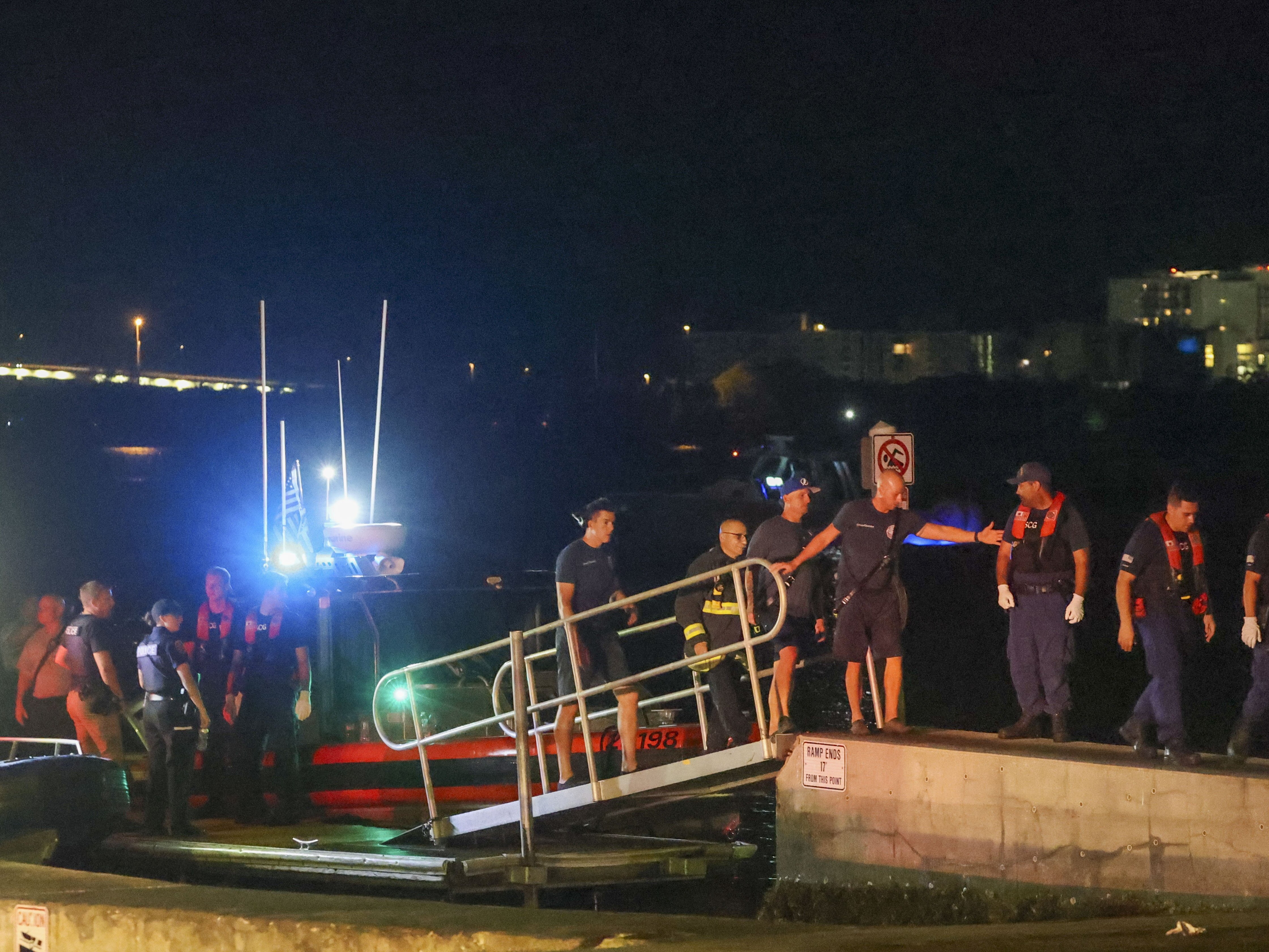 caption: Rescue workers gather at the Seminole Boat ramp north of where a boat crashed into the ferry causing multiple injuries near the Clearwater Memorial Causeway Bridge, on Sunday, April 27, 2025, in Clearwater, Fla.