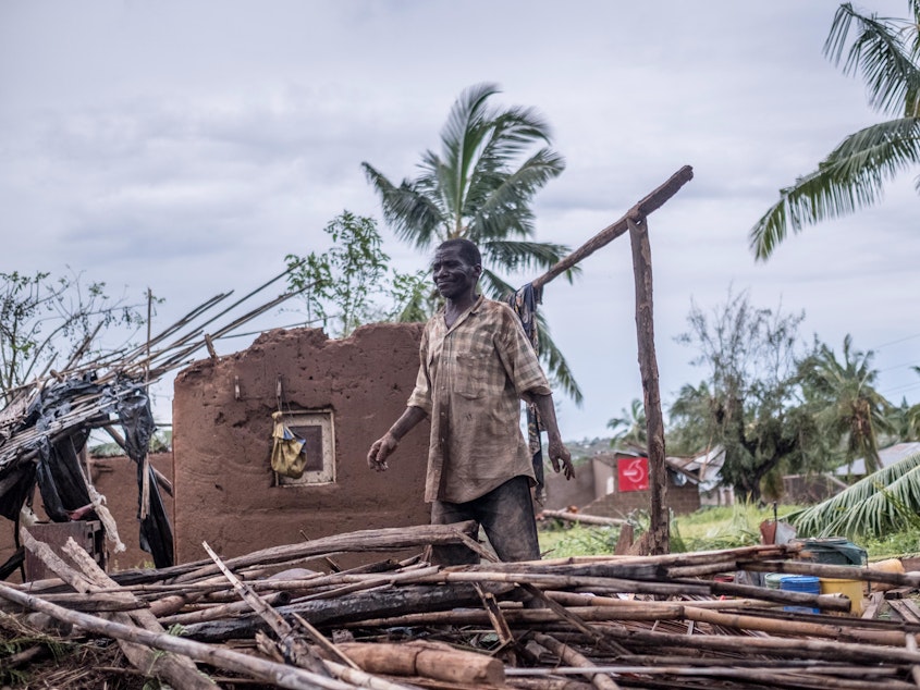 caption: A man stands in his wrecked home in Macomia, Mozambique, after Cyclone Kenneth in April. It was the second intense cyclone to strike the country in six weeks.