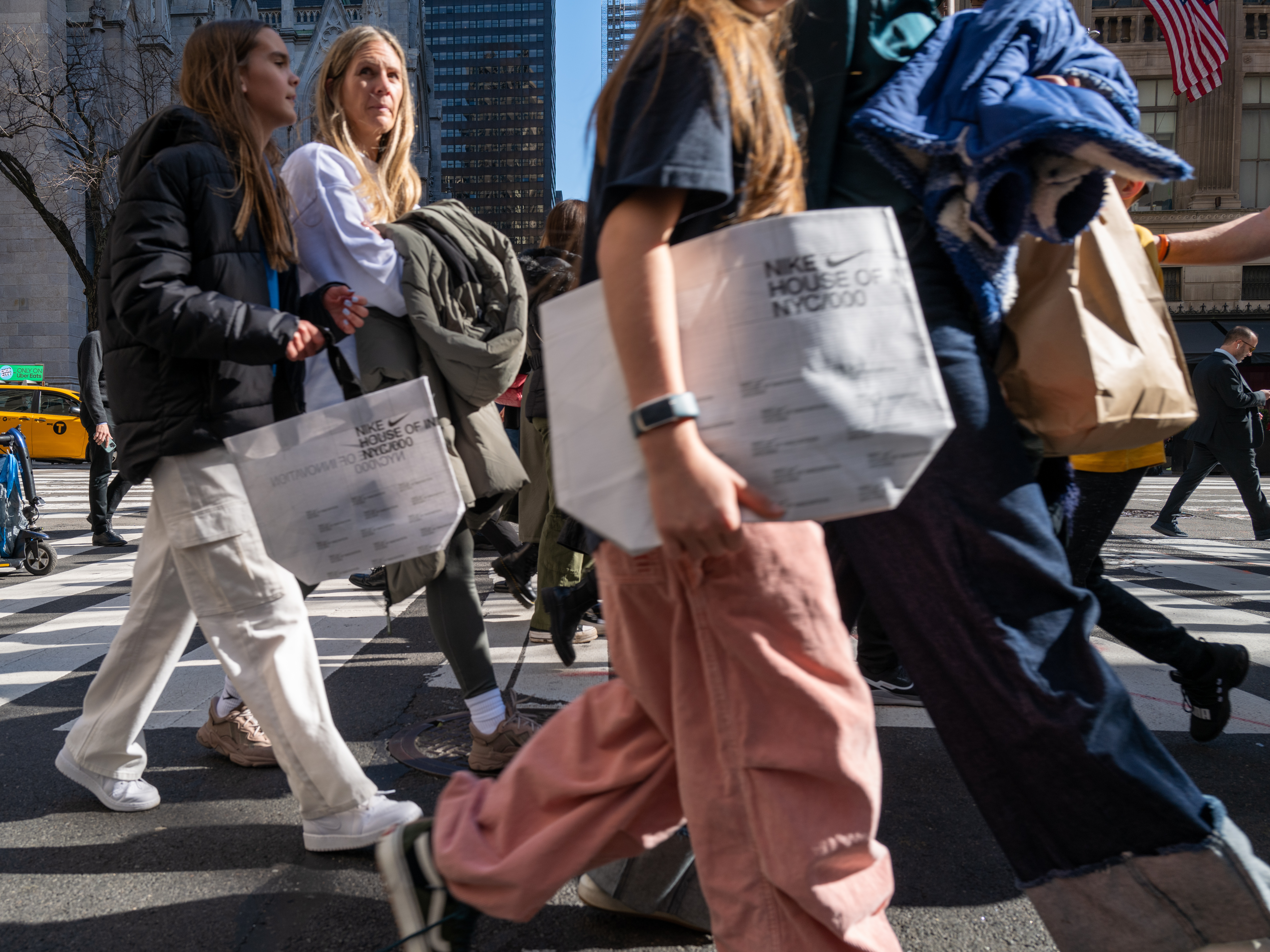 caption: People walk along 5th Avenue in Manhattan, which is one of the nation's premier shopping streets, on Feb. 15, 2023. Consumer spending was unexpectedly strong last month. That's good for the economy – but not so good for inflation prospects.