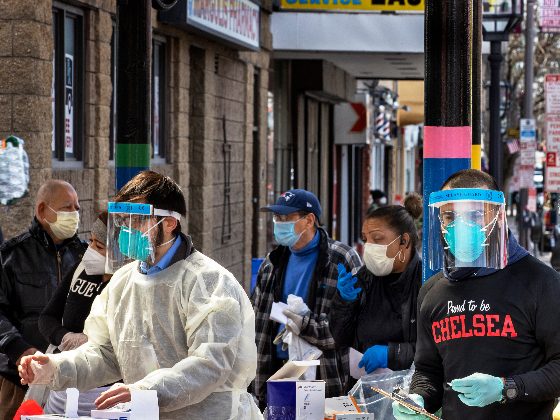 caption: People line up in mid-April in Chelsea, Mass., to get antibody tests for the coronavirus that causes COVID-19.