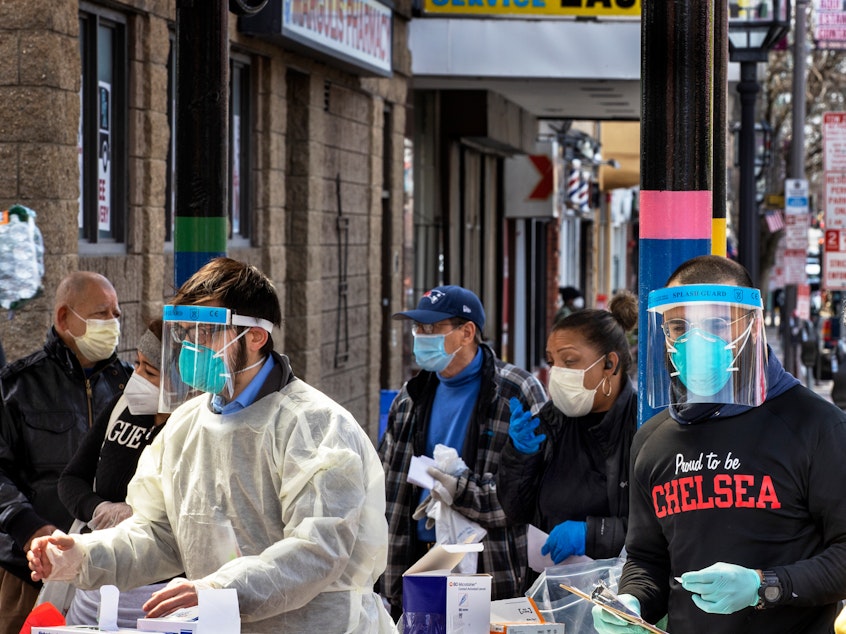 caption: People line up in mid-April in Chelsea, Mass., to get antibody tests for the coronavirus that causes COVID-19.