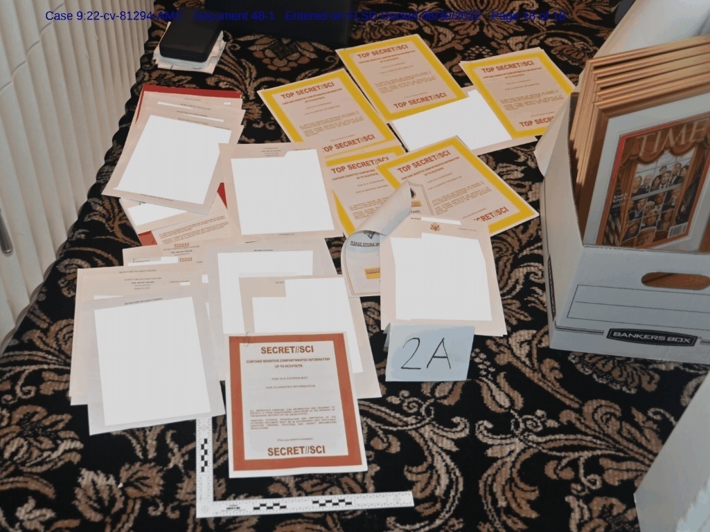 caption: This image contained in a court filing by the Department of Justice on Aug. 30, and redacted by in part by the FBI, shows a photo of documents seized during the Aug. 8 search by the FBI of former President Donald Trump's Mar-a-Lago estate in Florida.