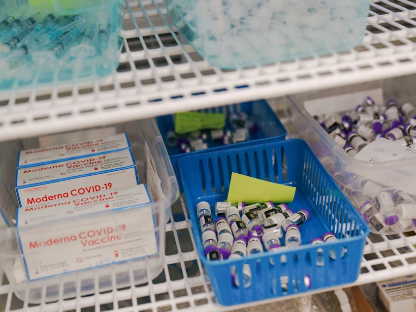 caption: Moderna and Pfizer COVID-19 vaccines sit in a refrigerator at a mass vaccination site in June in Cranston, R.I. As demand for vaccines lags in the U.S., expiration dates loom. At the same time, lower-income countries are eager for more doses as infections rise.