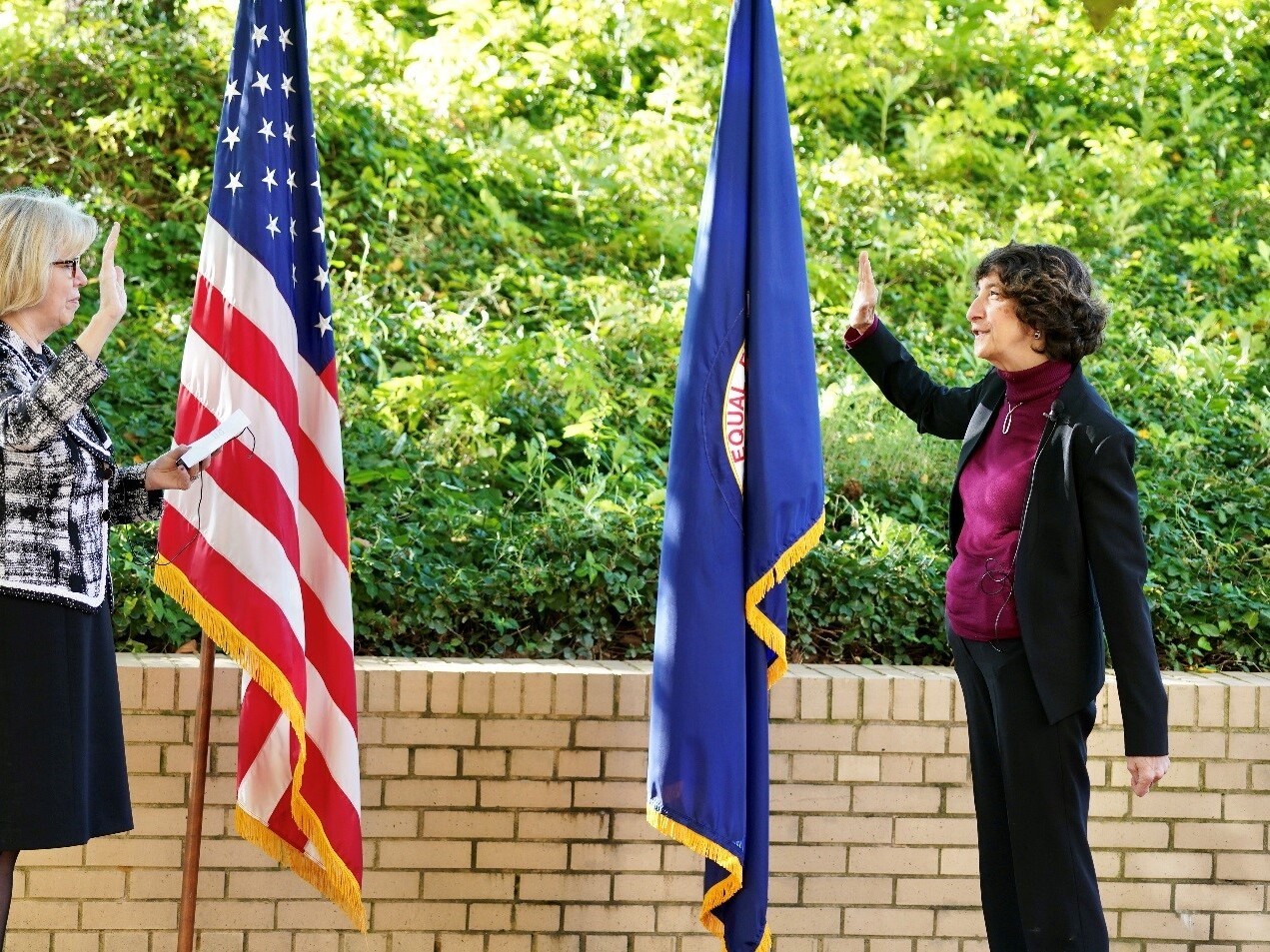 caption: Former EEOC Commissioner Jocelyn Samuels, shown at right, President Trump's pick in his first term to fill a Democratic seat on the commission, is sworn in by then-EEOC Chair Janet Dhillon, left, on October 14, 2020.