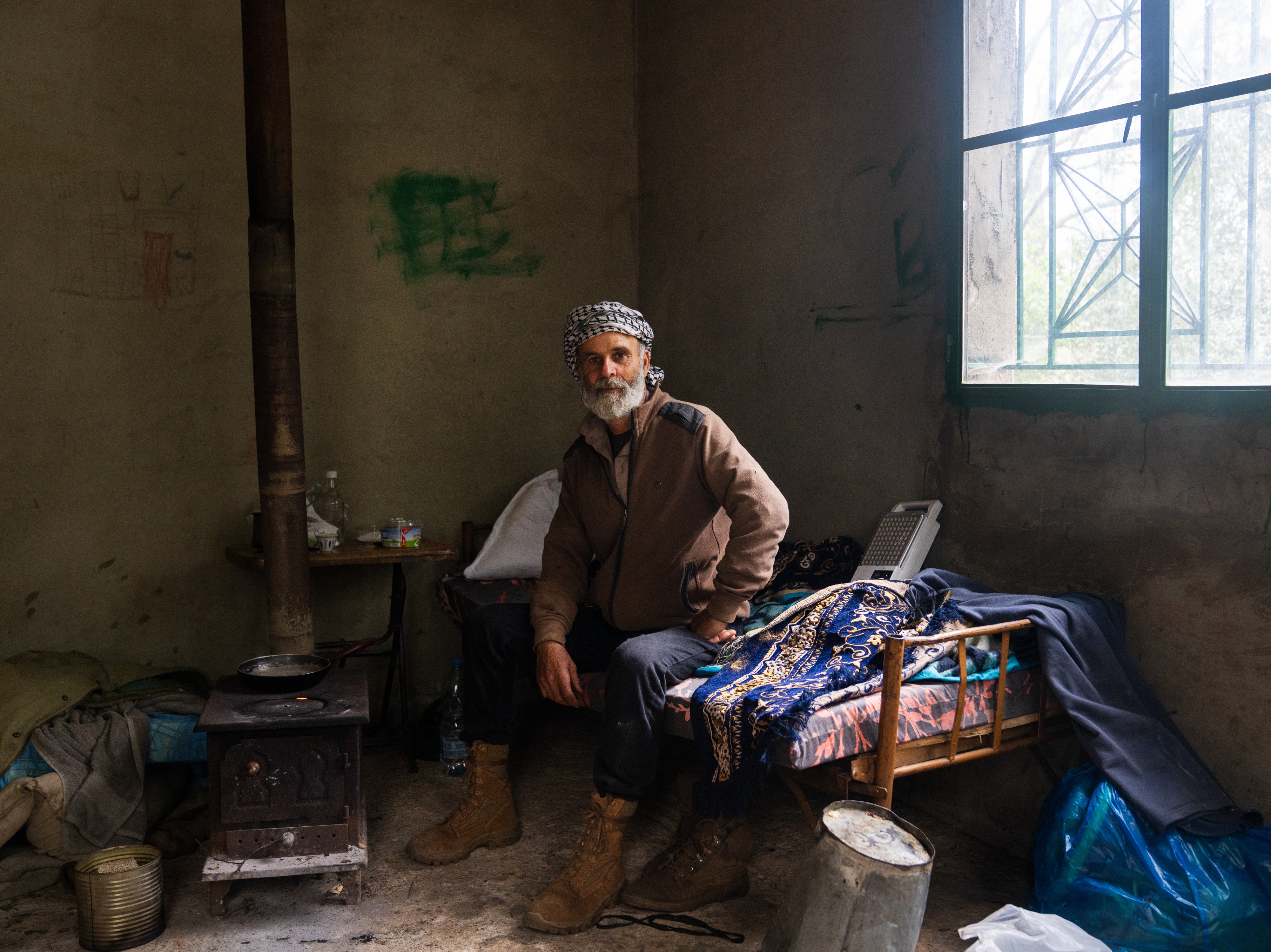 caption: Joseph Elias Issa, 56, was displaced from Kfar Houneh where he lived with his family in southern Lebanon following the Israeli invasion. A farmer, he took two mules and is now staying in a a shepherd's hut in Jezzine, about 5 miles away from his home.