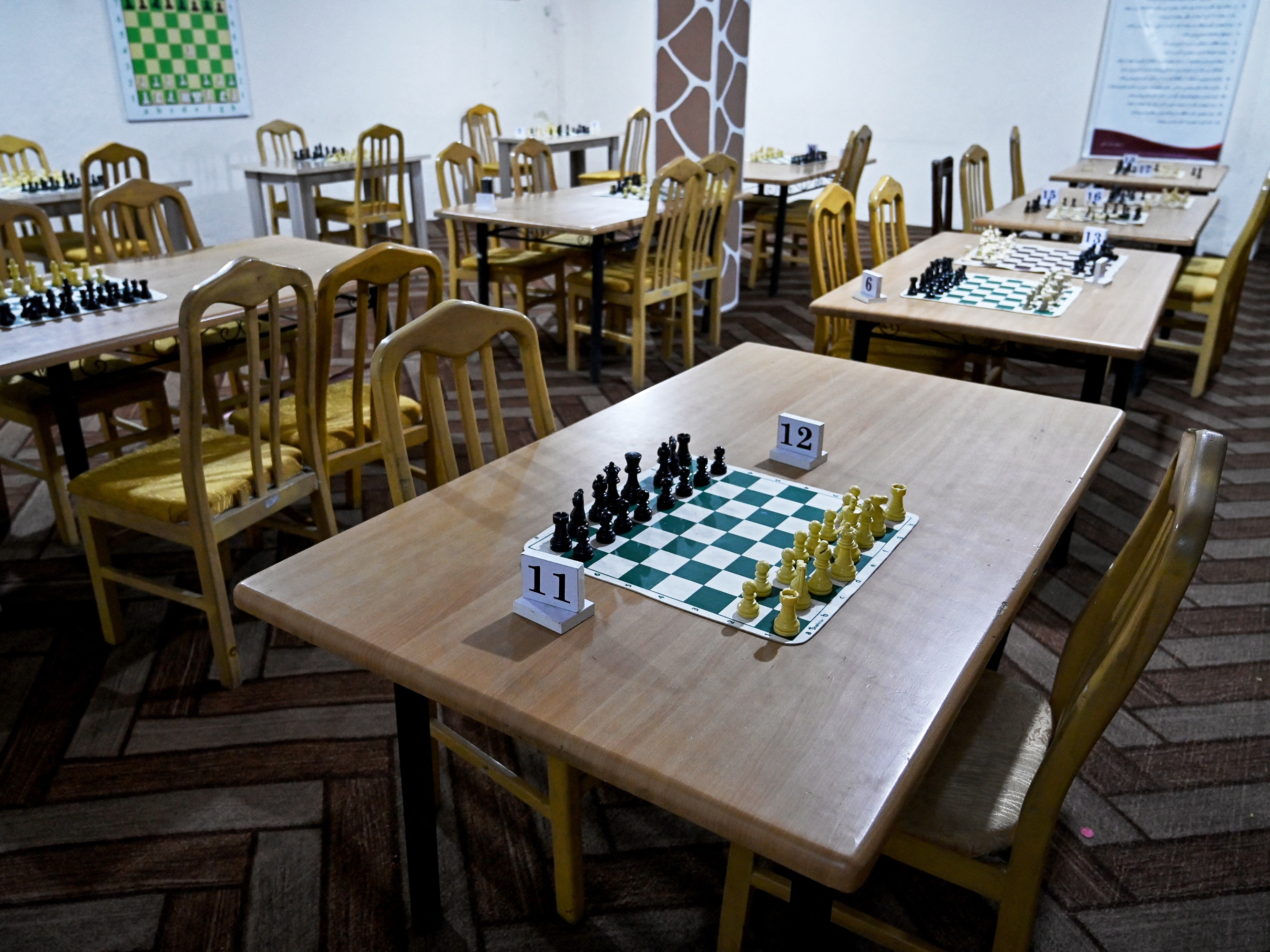 caption: Chessboards have no players at the Kabul Elite Chess Club in Kabul after Taliban authorities have barred the game across Afghanistan.