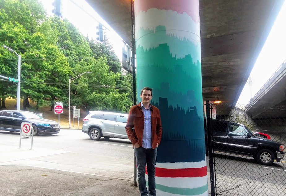 caption: Nathan Watkins, the designer of 68 Interstate 5 pillars between Cherry and James Streets in downtown Seattle.