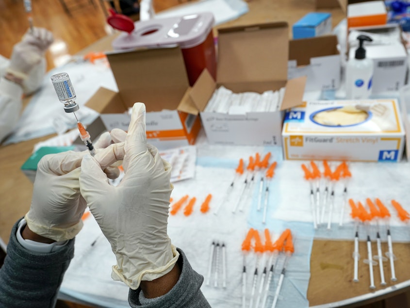 caption: A nurse fills a syringe with a COVID-19 vaccine in the Staten Island borough of New York on April 8, 2021. The Food and Drug Administration on Thursday recommended that COVID booster shots be modified to better match more recent variants of the coronavirus.