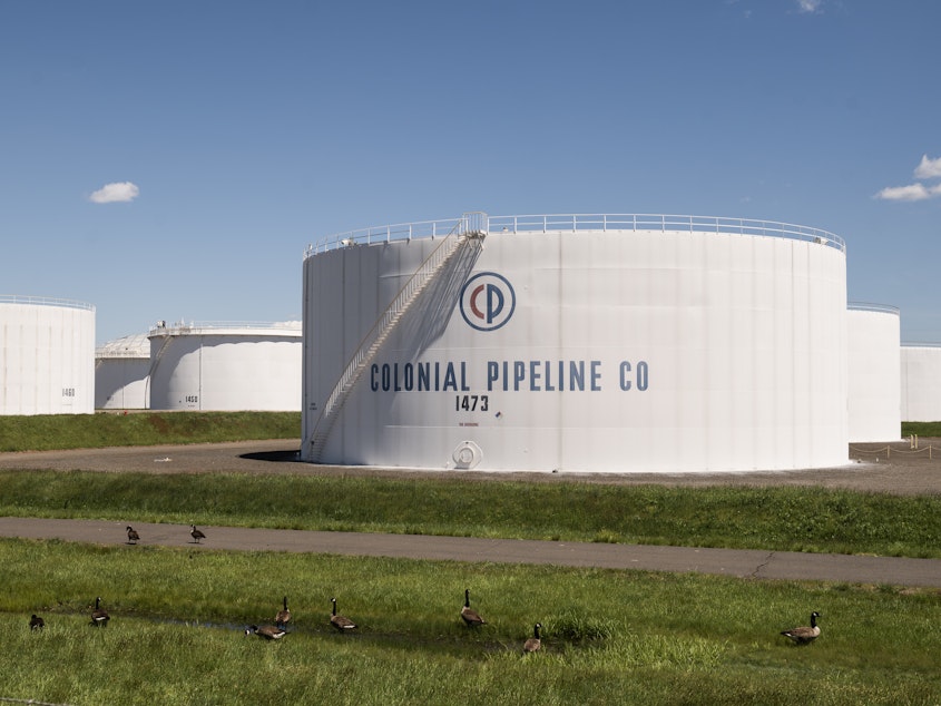 caption: President Biden alluded to the Colonial Pipeline cyberattack in his new executive order. Here, storage tanks at a Colonial facility are seen Wednesday in Avenel, N.J.