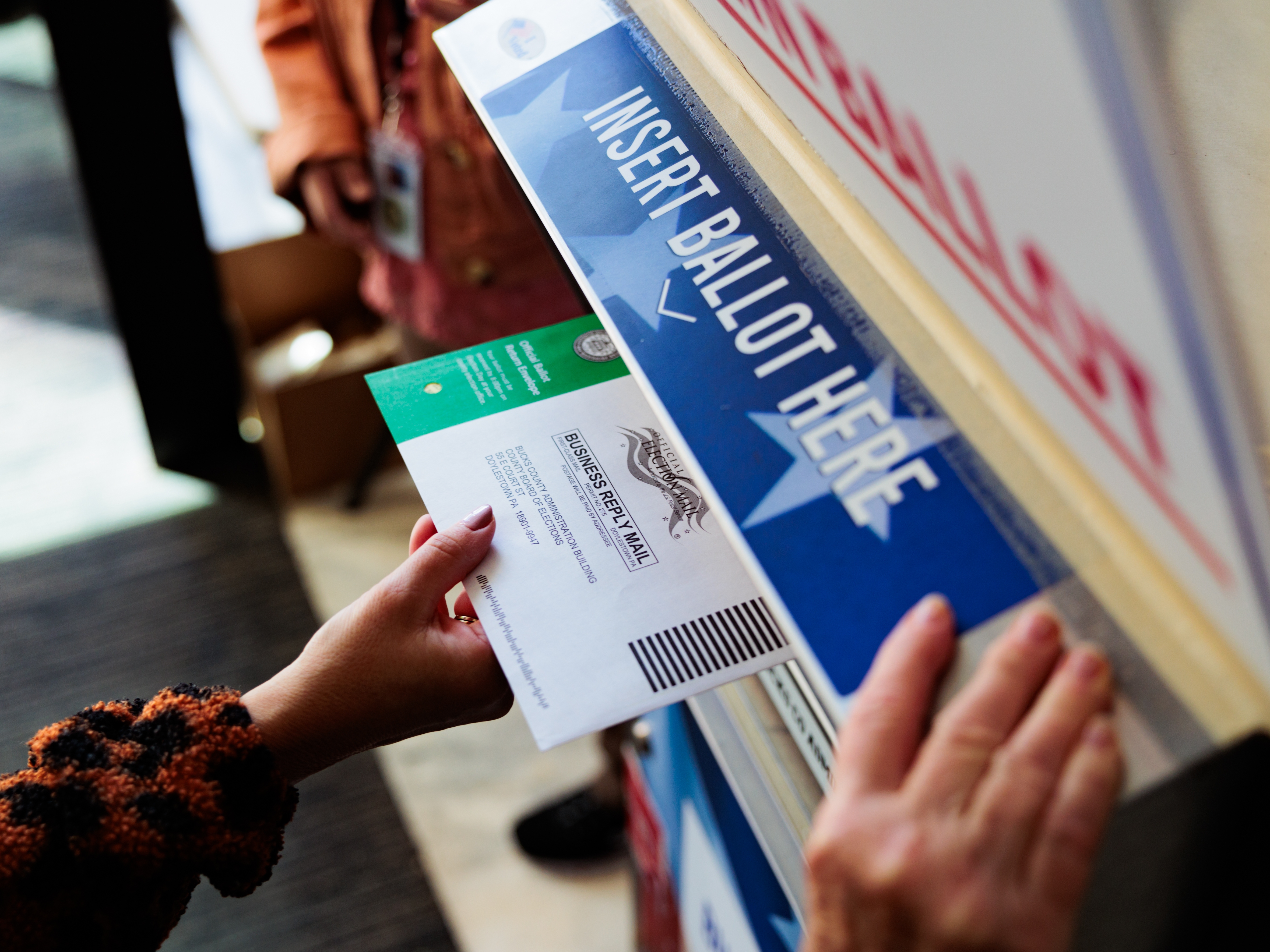 caption: A person drops off a mail-in ballot on Oct. 15 in Doylestown, Pennsylvania. An unknown number of women are hiding their choice of Vice President Harris from family and partners in an election that is projected to have a historic gender gap.