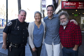caption: Seattle Police Officer Kevin O'Neill, Deborah Wang, Bill Radke, and Knute Berger outside the KUOW studios in Seattle. 