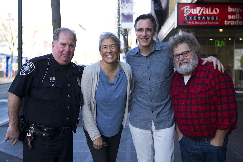 caption: Seattle Police Officer Kevin O'Neill, Deborah Wang, Bill Radke, and Knute Berger outside the KUOW studios in Seattle. 