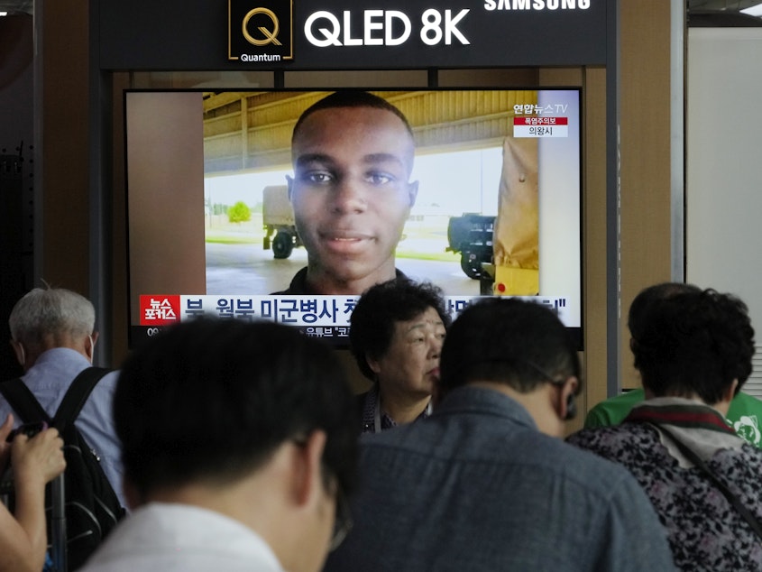 caption: A TV screen shows a file image of U.S. soldier Travis King during a news program at the Seoul Railway Station in Seoul, South Korea, Wednesday, Aug. 16, 2023.