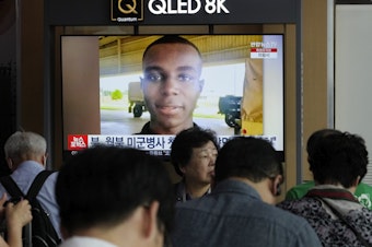 caption: A TV screen shows a file image of U.S. soldier Travis King during a news program at the Seoul Railway Station in Seoul, South Korea, Wednesday, Aug. 16, 2023.