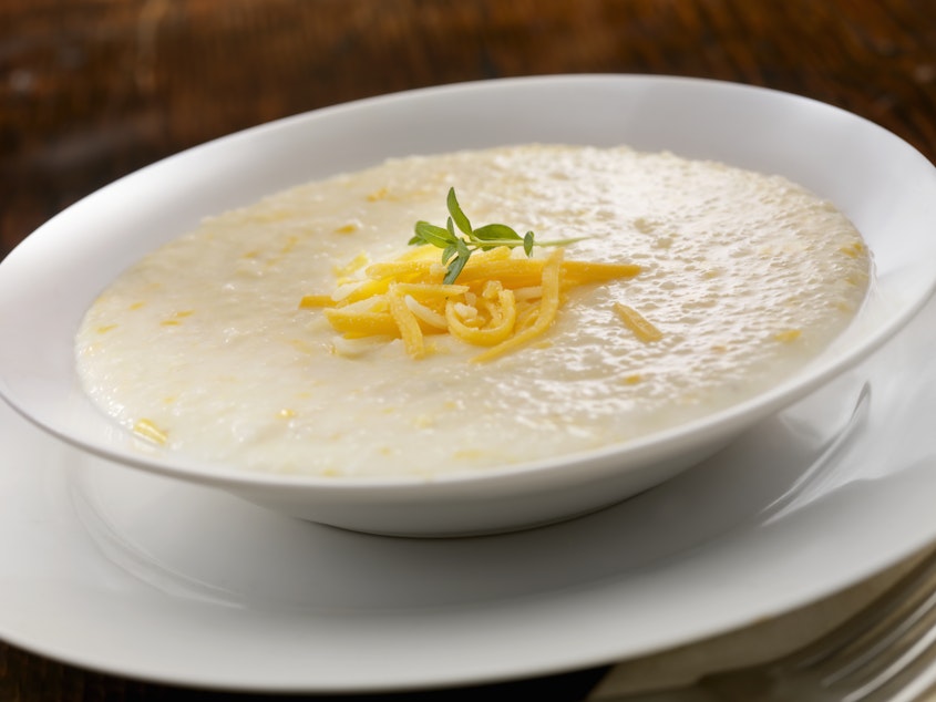 caption: A bowl of creamy cheese grits. Food writer Erin Byers Murray hopes that exploring the story of grits will help spur more discussion about how food shapes our culture, as humble ingredients are elevated into expensive dishes even as we come to terms with long-lost, or ignored, origin stories that deserve recognition.