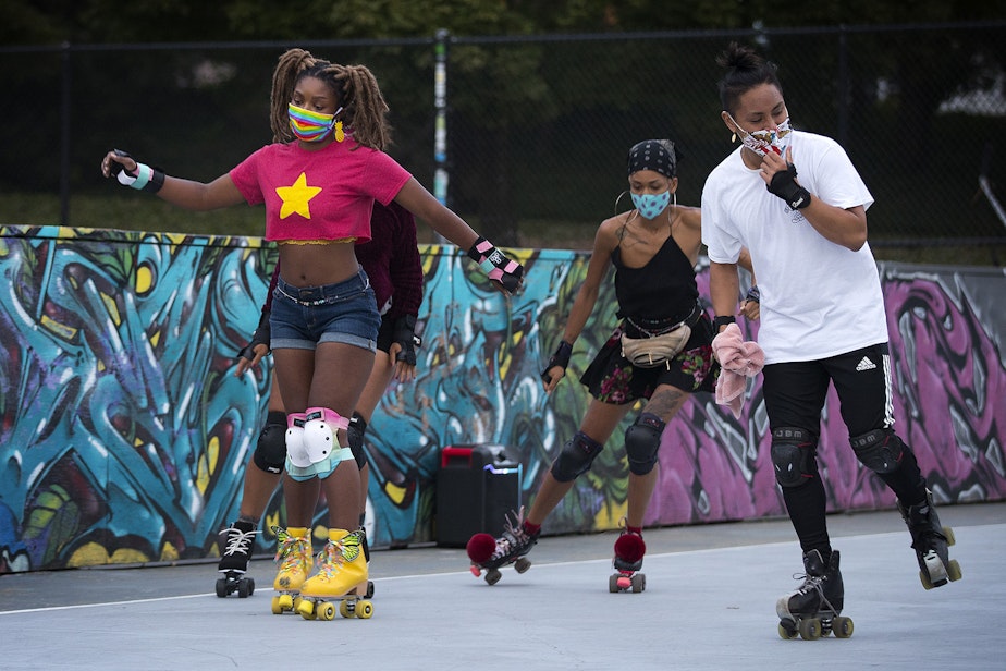 caption: Zenobia Taylor, left, skates on Tuesday, September 22, 2020, at the Judkins Park sports courts in Seattle. 