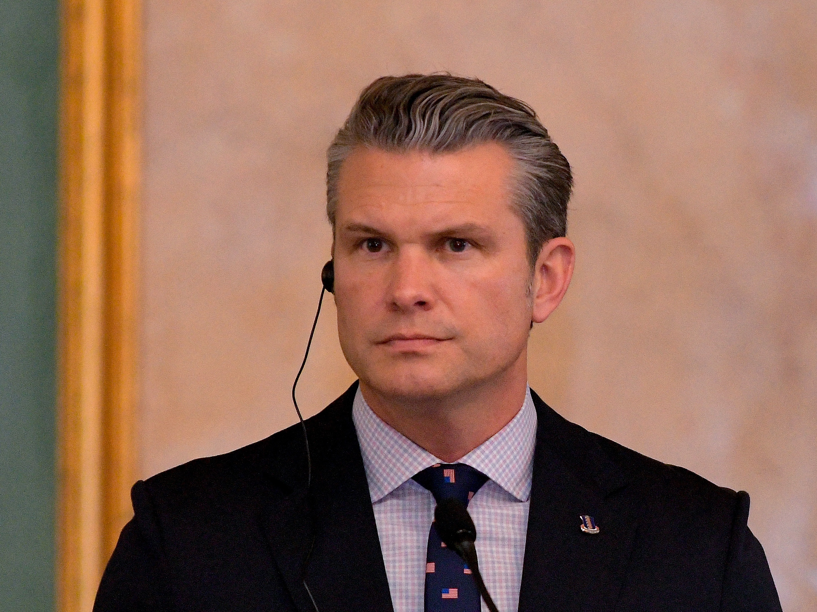 caption: Defense Secretary Pete Hegseth, pictured at a late Novermber press conference, is facing scrutiny for U.S. attacks on alleged drug boats — and a parody of a children's book cover.
