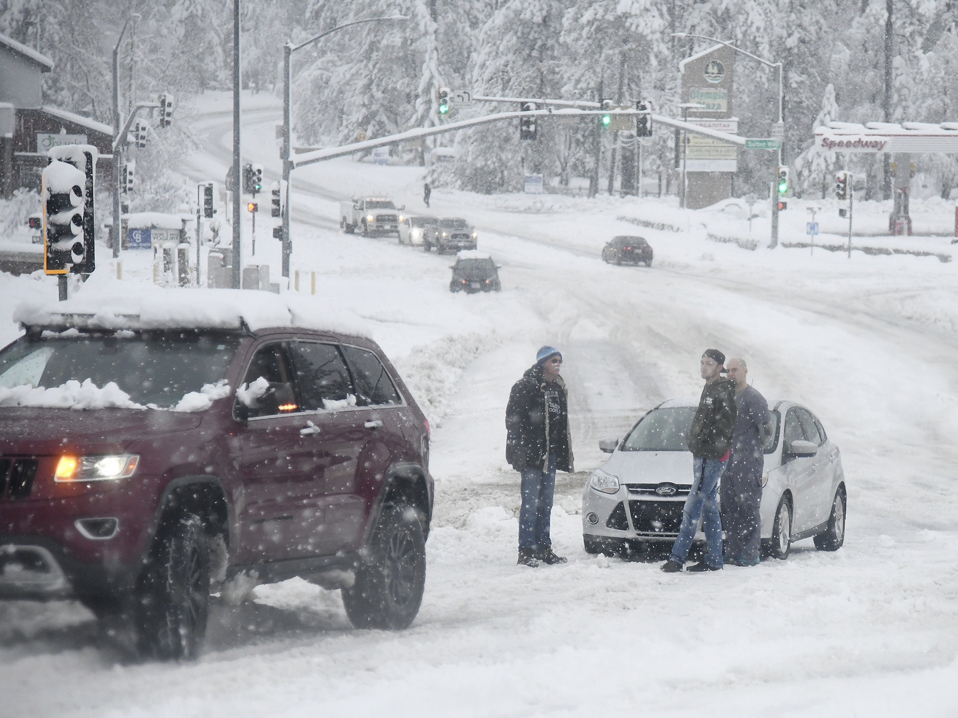 caption: Stuck motorists are seen along Brunswick Road as heavy snow continues to fall early Monday, in Grass Valley, Calif.