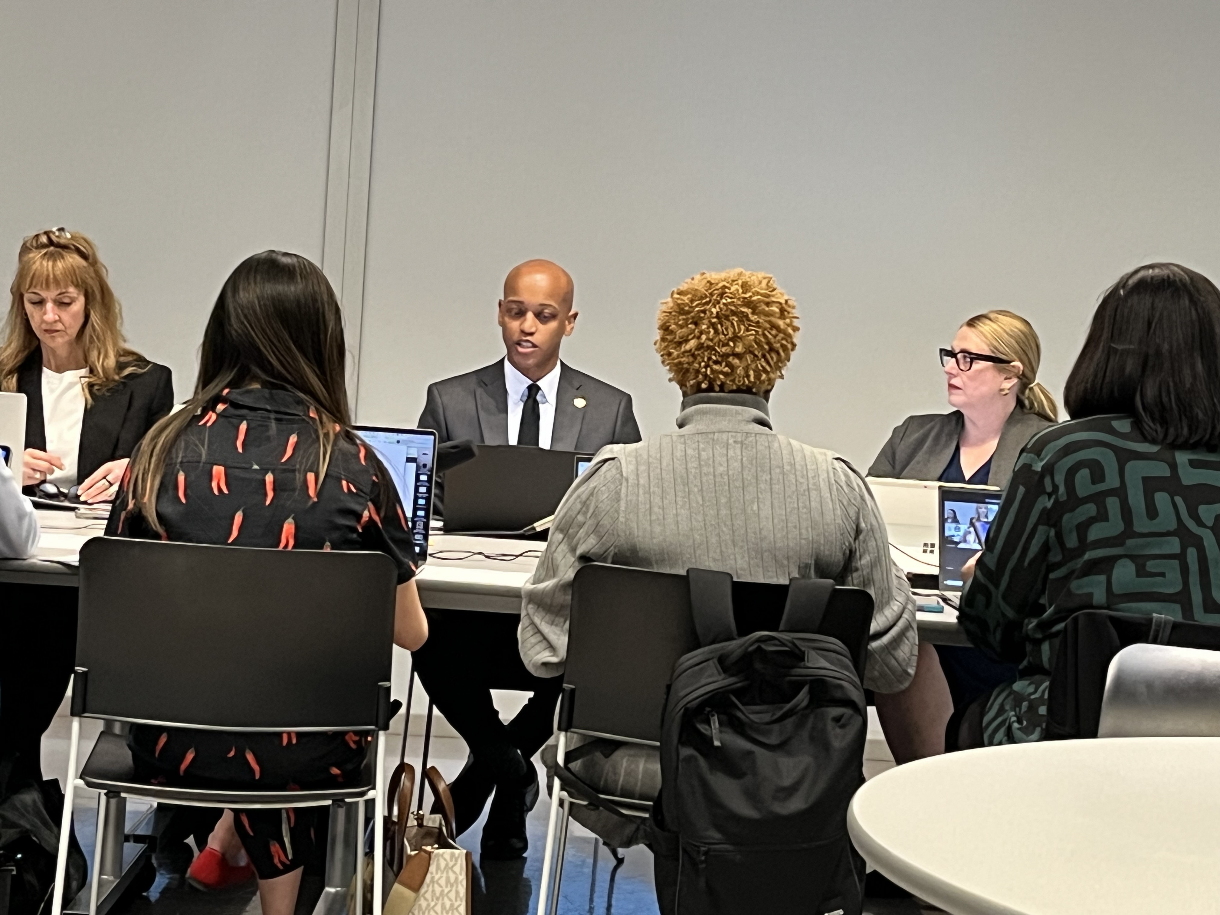 caption: King County Executive Girmay Zahilay, center, and KCRHA CEO Kelly Kinnison, right, at the April 24, 2026 board meeting discussing a new forensic audit. 