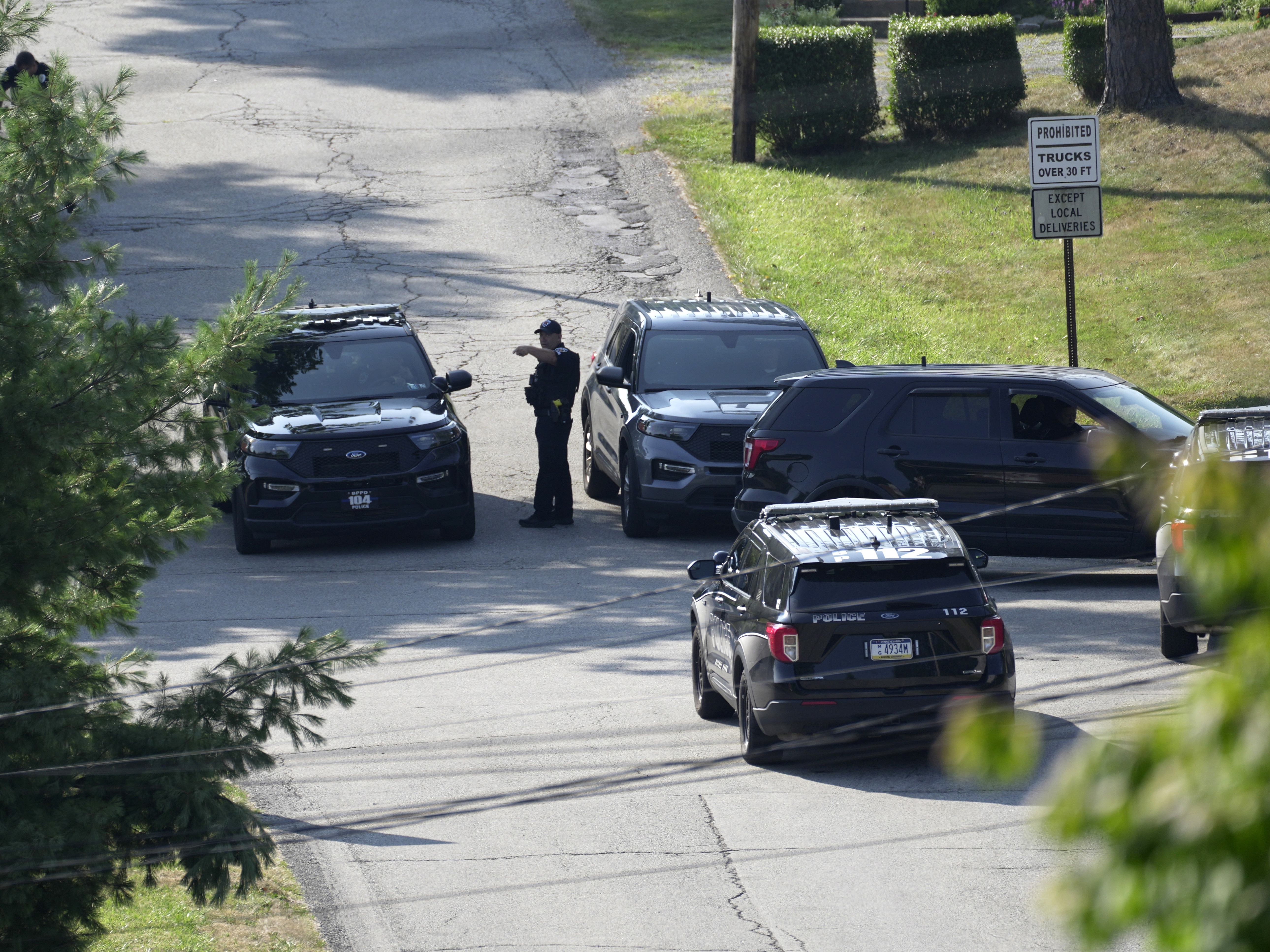 caption: Law enforcement block a street in Bethel Park, Pa., that they say was a residence of Thomas Matthew Crooks, the suspected shooter of former President Donald Trump, on Sunday. 