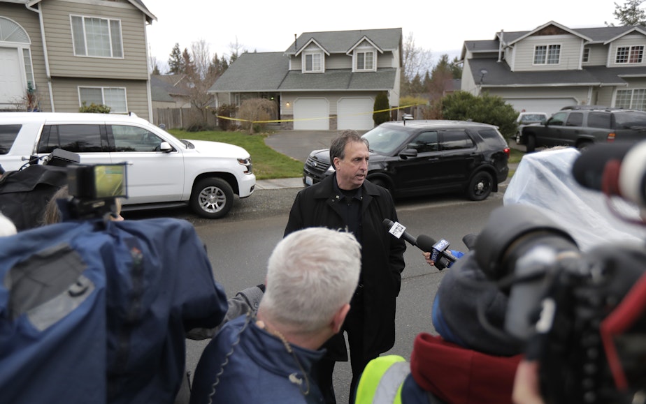 caption: Ed Troyer, center, talks to reporters, Tuesday, March 13, 2018. Troyer, who was elected Pierce County Sheriff in 2020 after serving as the sheriff department spokesperson, was acquitted this week of two counts of false reporting.
