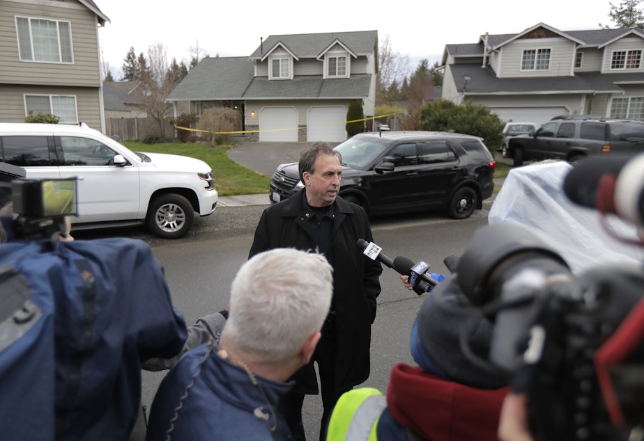 caption: Ed Troyer, center, talks to reporters, Tuesday, March 13, 2018. Troyer, who was elected Pierce County Sheriff in 2020 after serving as the sheriff department spokesperson, was acquitted this week of two counts of false reporting.