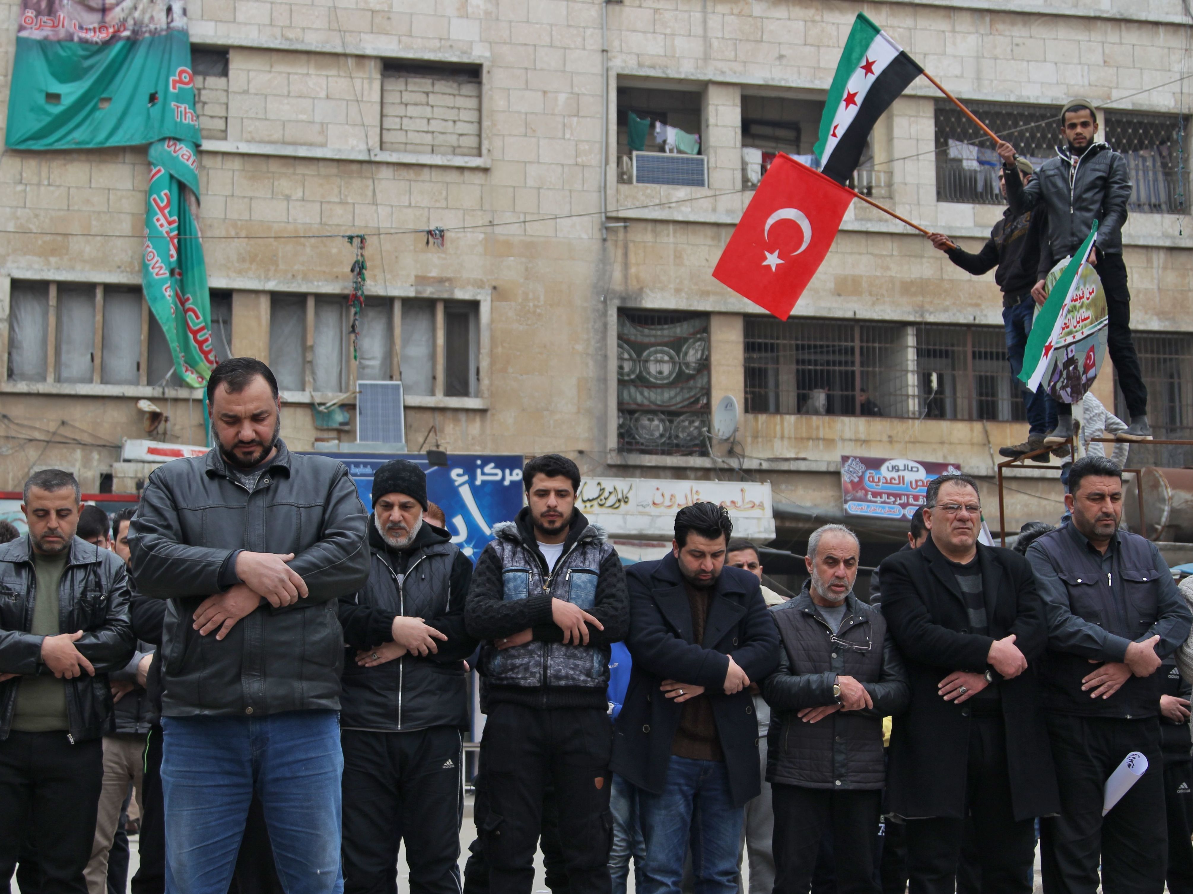 caption: Syrians in the northwestern city of Idlib perform funerary prayers for Turkish soldiers Friday. Turkey sought an urgent NATO meeting after at least 33 Turkish soldiers were killed in Syria's Idlib province Thursday.