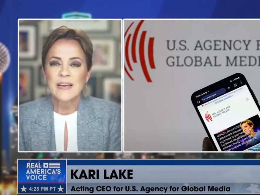 caption: Trump administration adviser Kari Lake, shown recently on the Real America's Voice cable TV channel, has sought to dismantle Voice of America and its federal parent, the U.S. Agency for Global Media. The agency has recently called her its acting CEO. But she may not be legally eligible for the job.