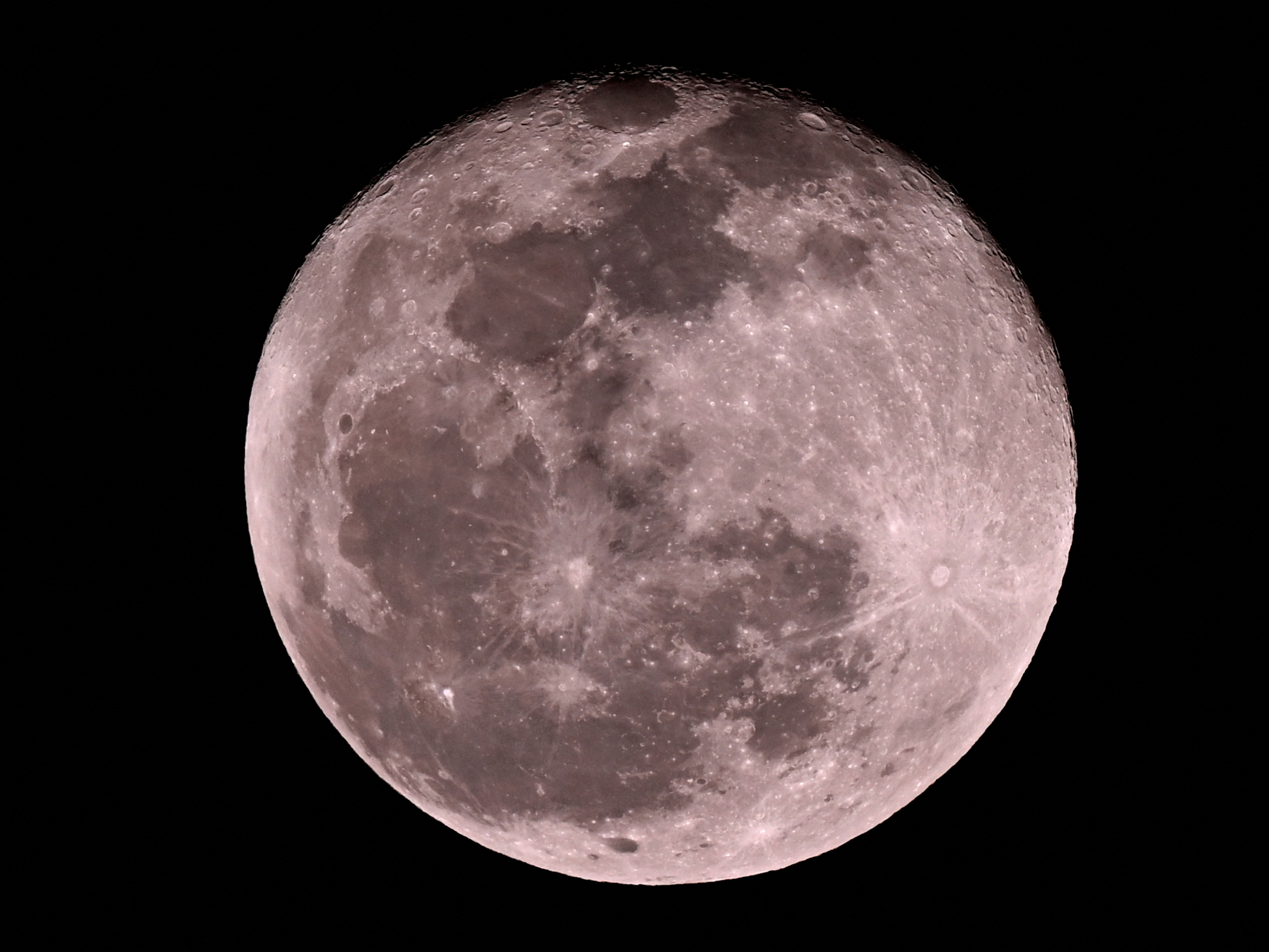 caption: The moon shines over the Marrara Oval ground during the T20 international cricket match between Australia and South Africa in Darwin on Aug. 10.