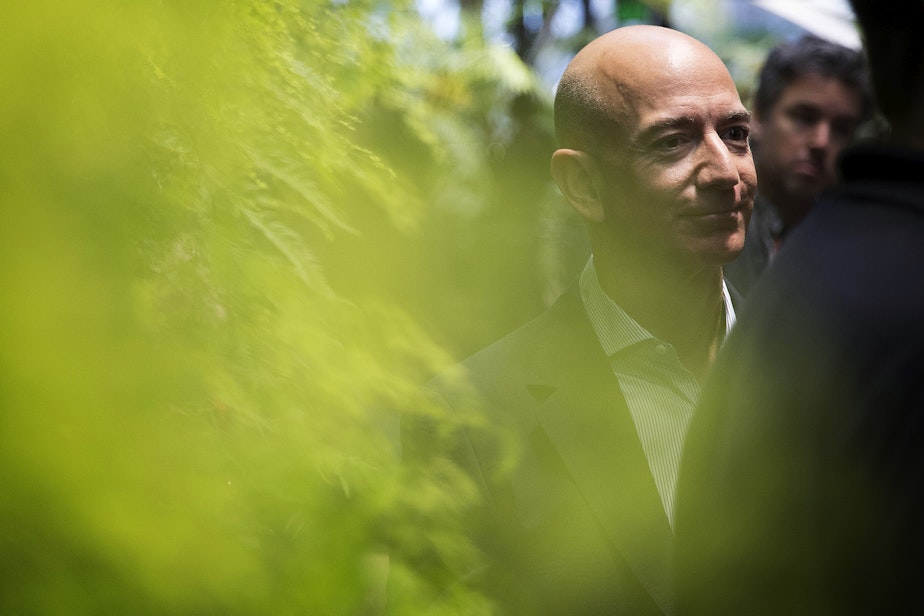 caption: Jeff Bezos stands next to the Canyon Living Wall on Monday, January 29, 2018, during the spheres grand opening in Seattle. 