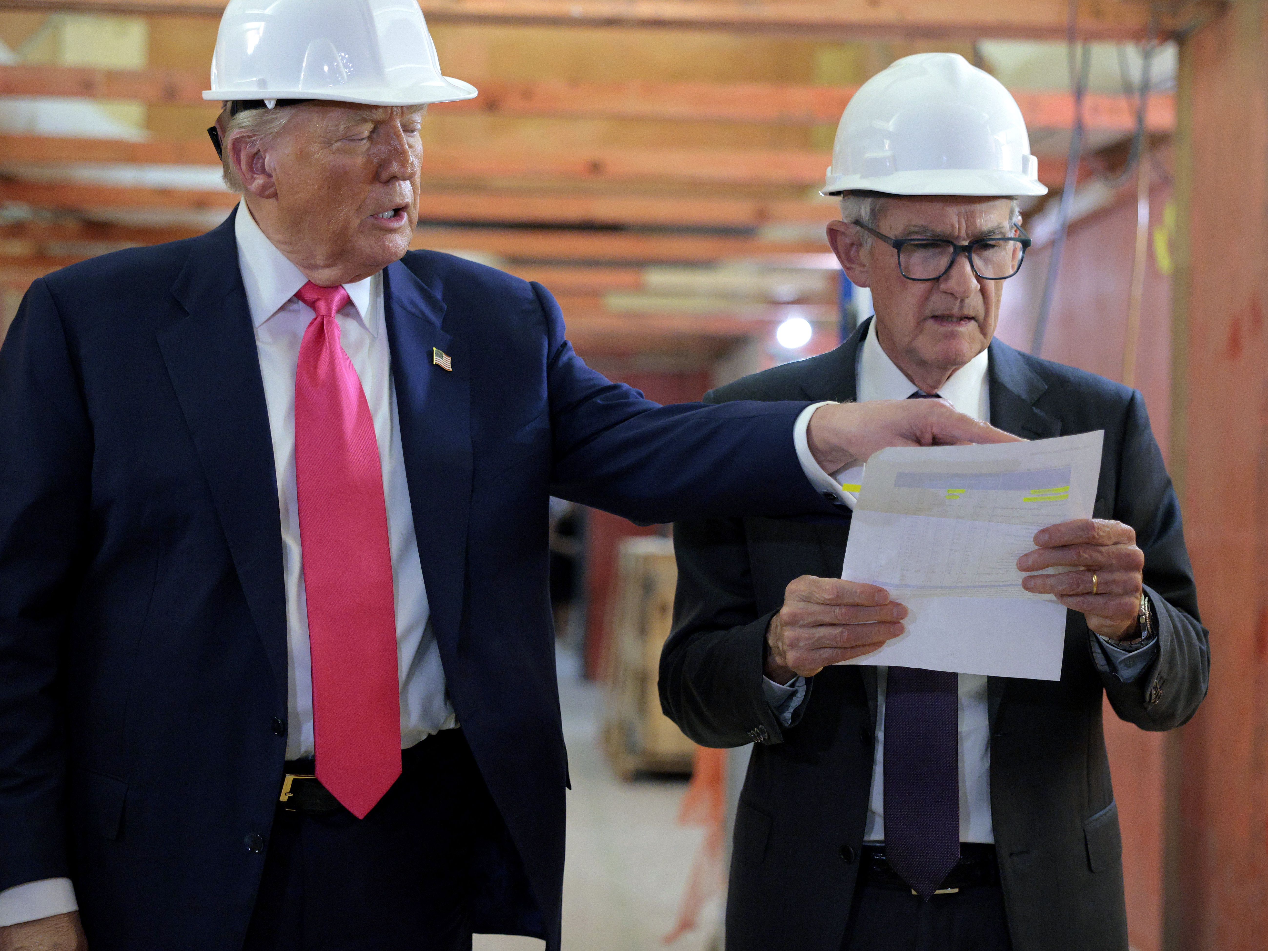 caption: Federal Reserve Chair Jerome Powell (right) and his colleagues are expected to leave interest rates unchanged Wednesday, despite calls for lower rates from President Trump. The president toured the central bank's headquarters renovation project with Powell last week.