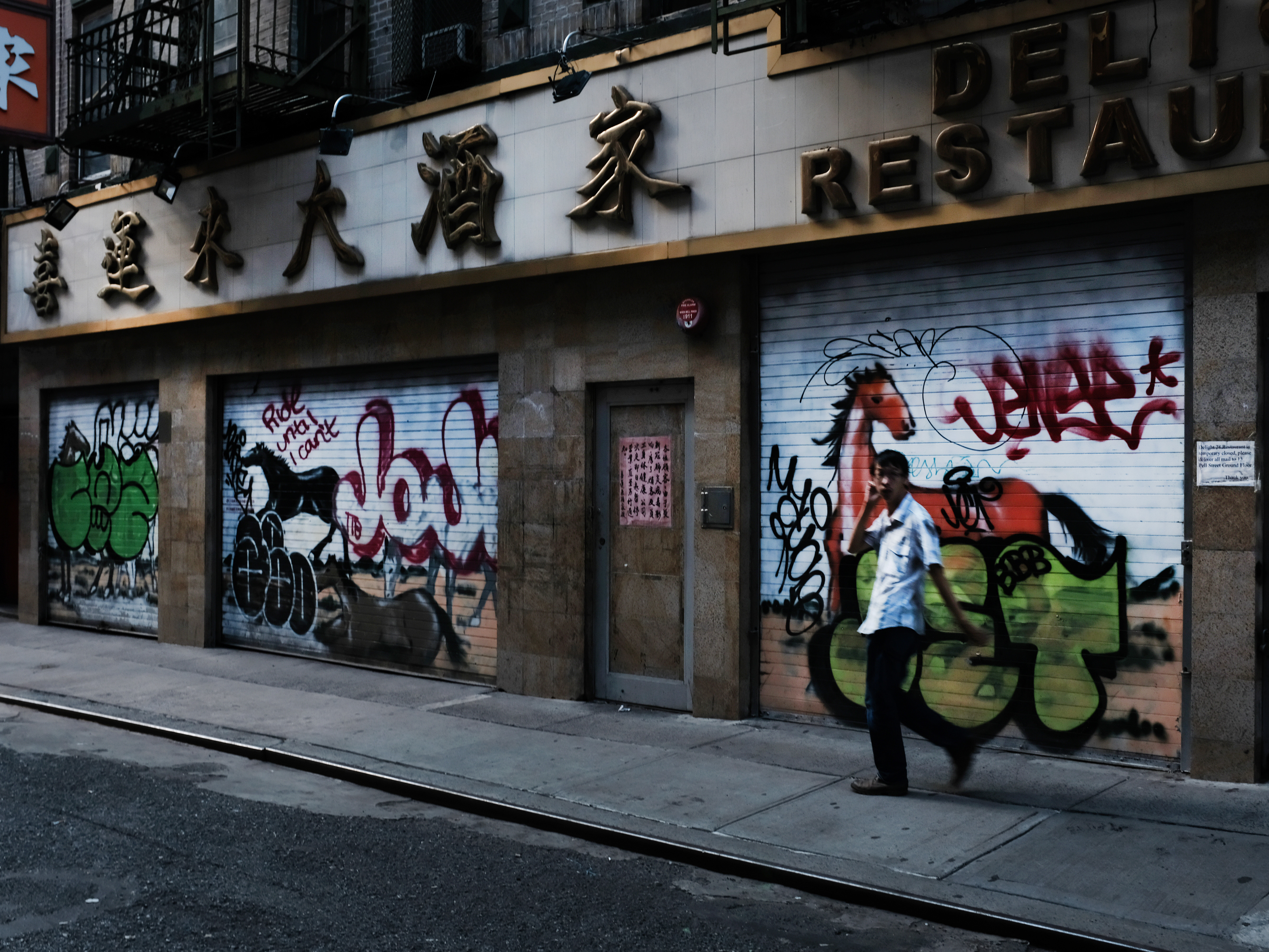caption: A man passes by a closed restaurant in New York City's Chinatown on Aug. 10, 2020. The unemployment rate for Asian Americans has surged amid the pandemic, a trend that has been overlooked amid the widespread economic misery.