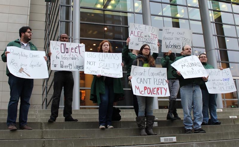 caption: Workers and labor activists demonstrate outside the US District Courthouse on March 11, 2015, the day attorneys made oral arguments on the injunction