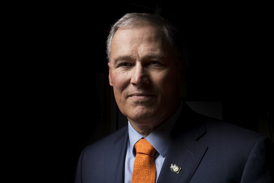 caption: Jay Inslee poses for a portrait on Thursday, January 11, 2018, in Seattle. 